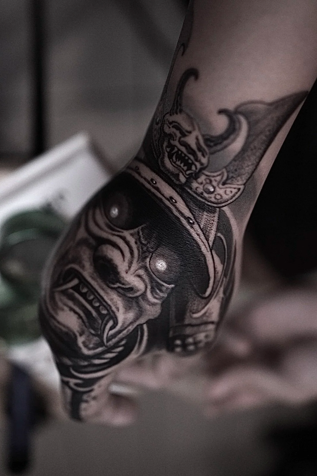 Detailed black-and-gray dragon and skull forearm tattoo at Black Craft Tattoo Collective.