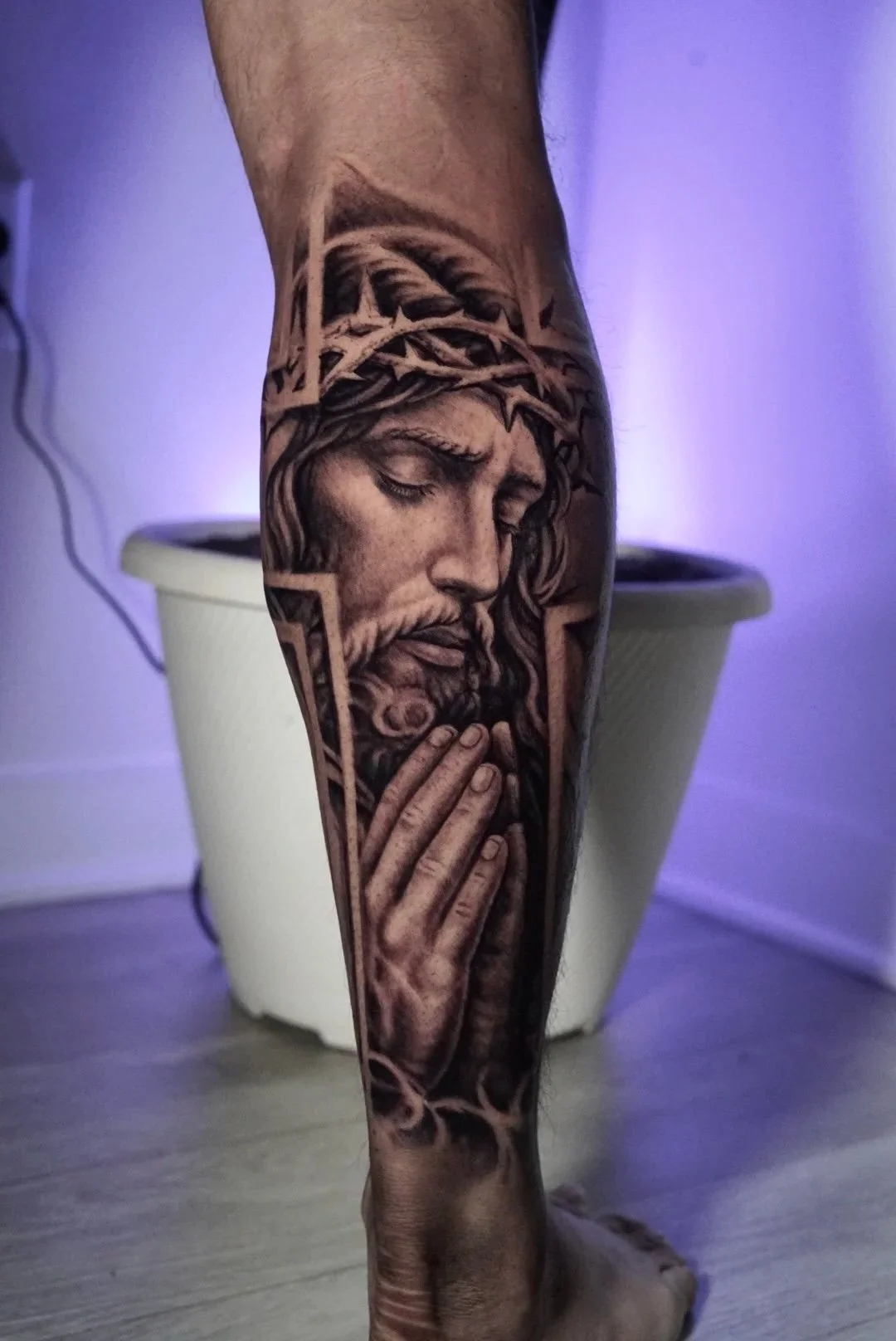 Black-and-gray praying Jesus lower-leg tattoo by Luis Dajer in Charlotte, NC.