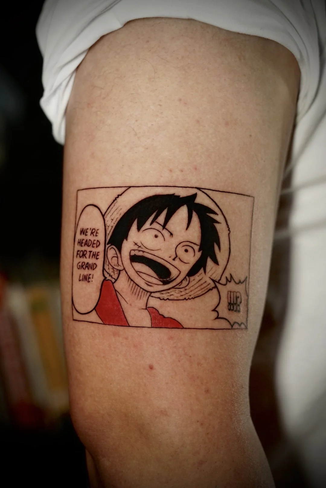 Color One Piece manga character and speech-bubble arm tattoo by Luis Dajer.