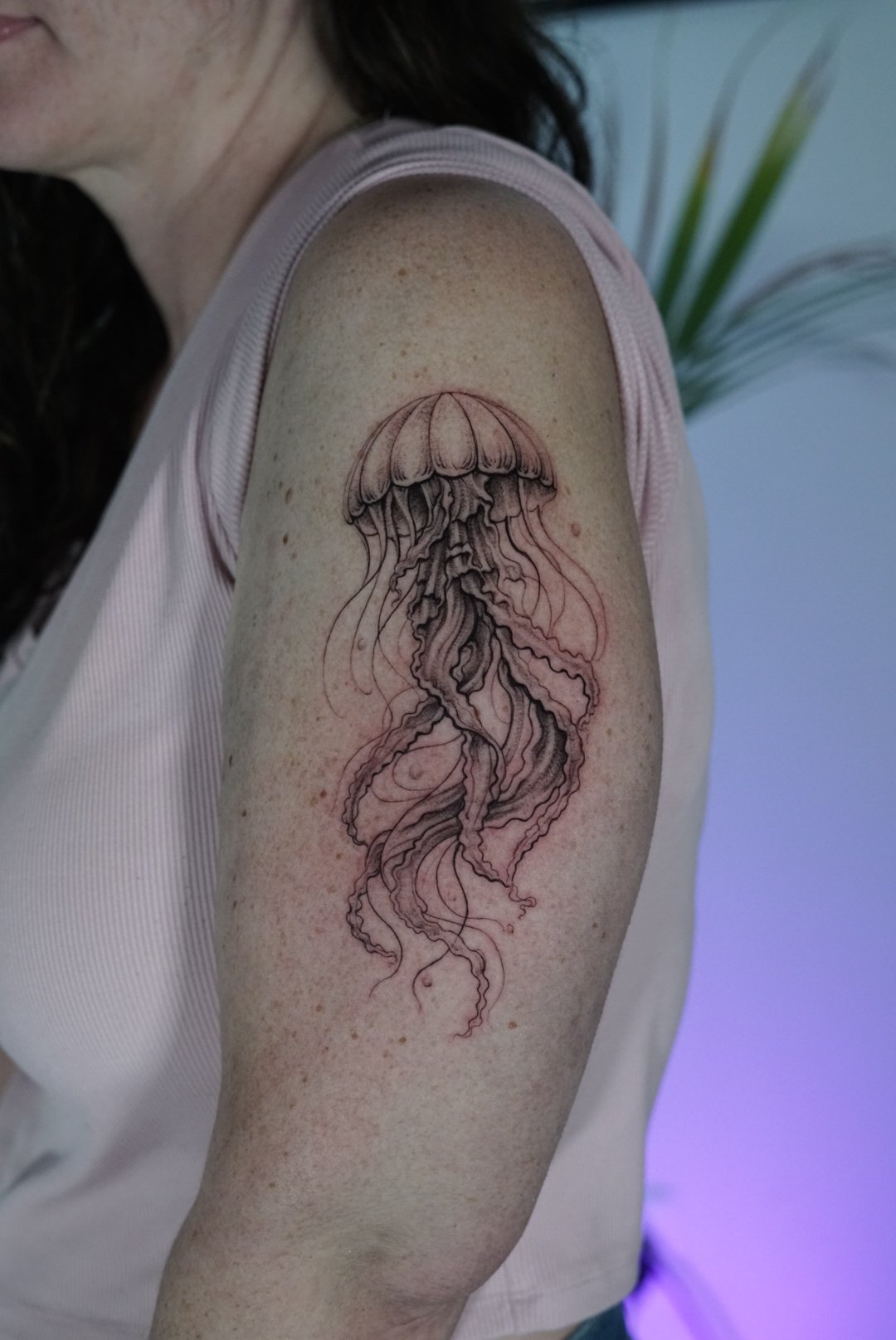 Detailed fine-line jellyfish upper-arm tattoo by Luis Dajer at Black Craft Tattoo Collective.