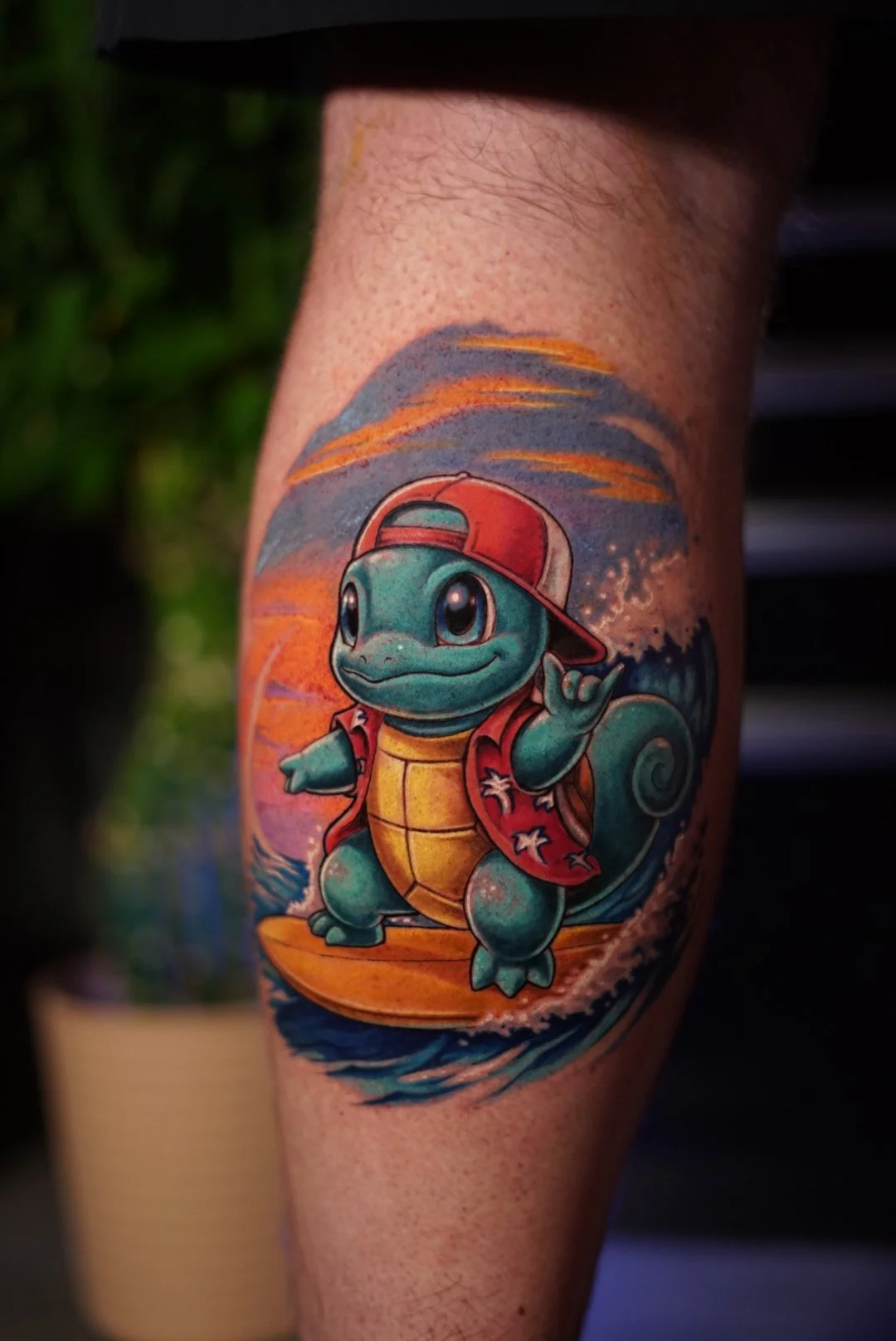 Color Squirtle surfing tattoo with sunset and beach clothing by Luis Dajer.