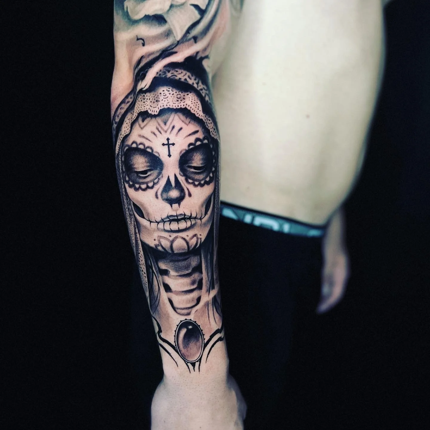 Detailed black-and-gray sugar-skull arm tattoo by Luis Dajer in Charlotte, NC.