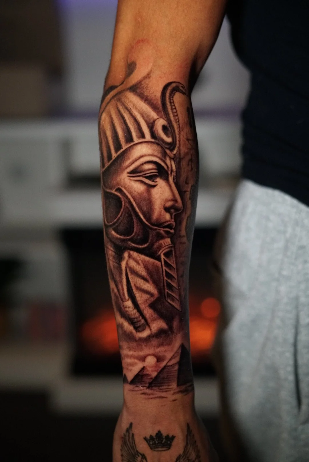 Black-and-gray helmeted woman profile forearm tattoo by Luis Dajer.