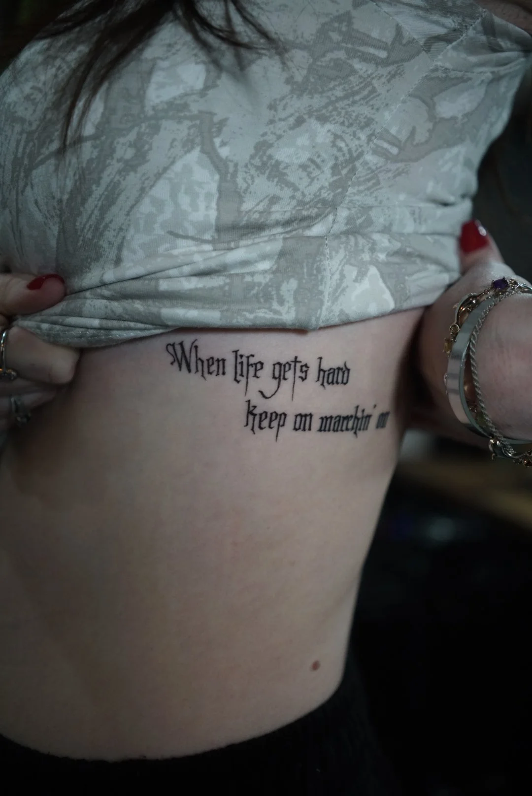 Fine-line motivational quote rib tattoo by Luis Dajer in Charlotte, NC.