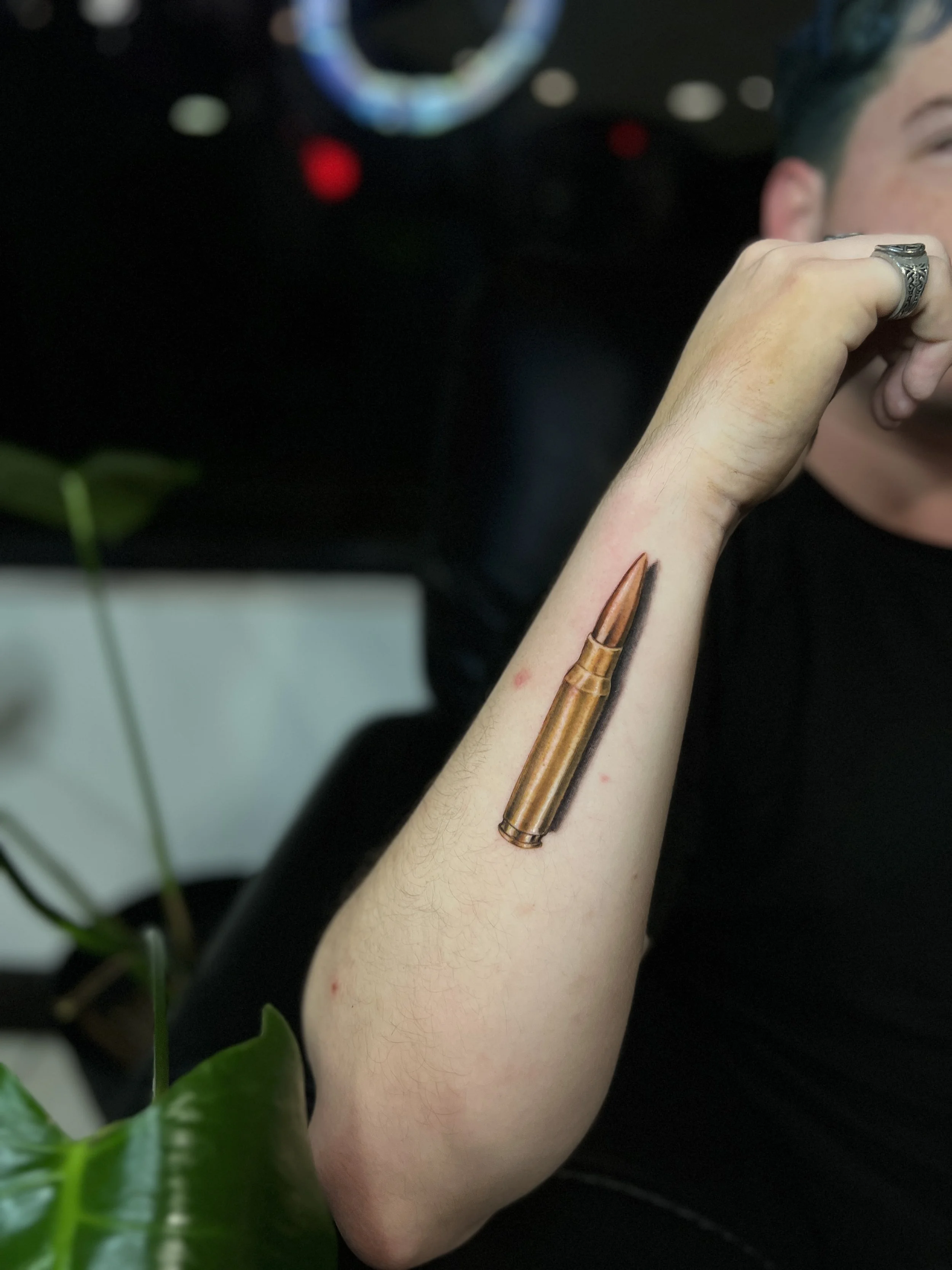 Gold bullet forearm tattoo by Luis Dajer at Black Craft Tattoo Collective.
