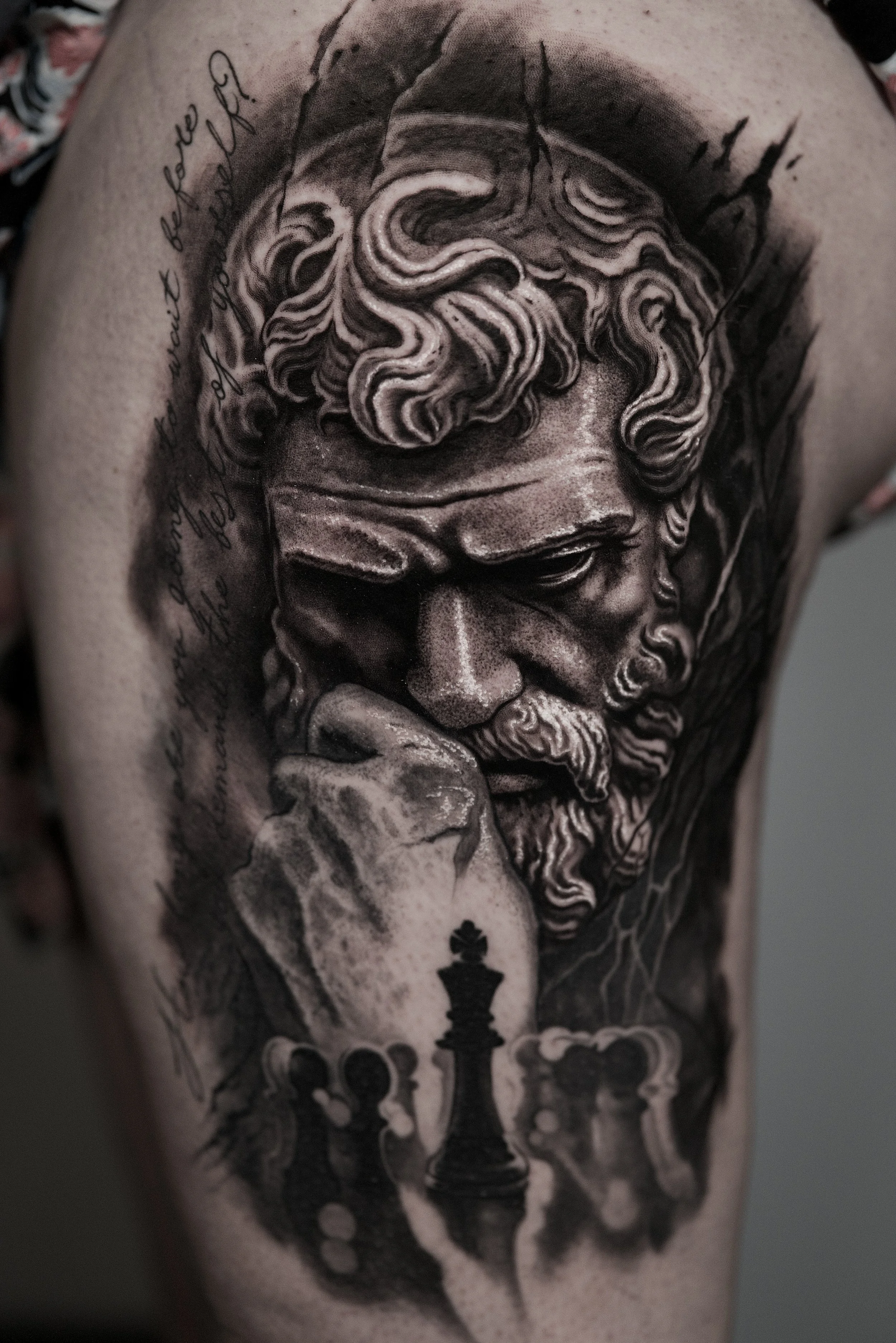 Black-and-gray classical statue and chess king tattoo with ornate script at Black Craft Tattoo Collective in Charlotte, NC.