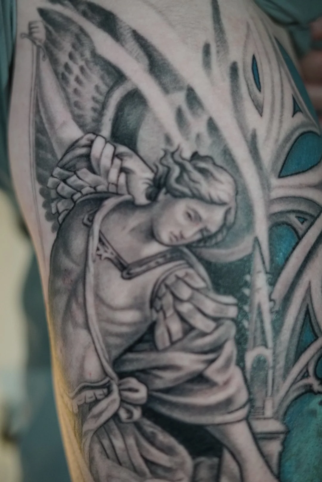 Healed black-and-grey angel realism tattoo with architectural details by Luis Dajer at Black Craft Tattoo Collective in Charlotte, NC.