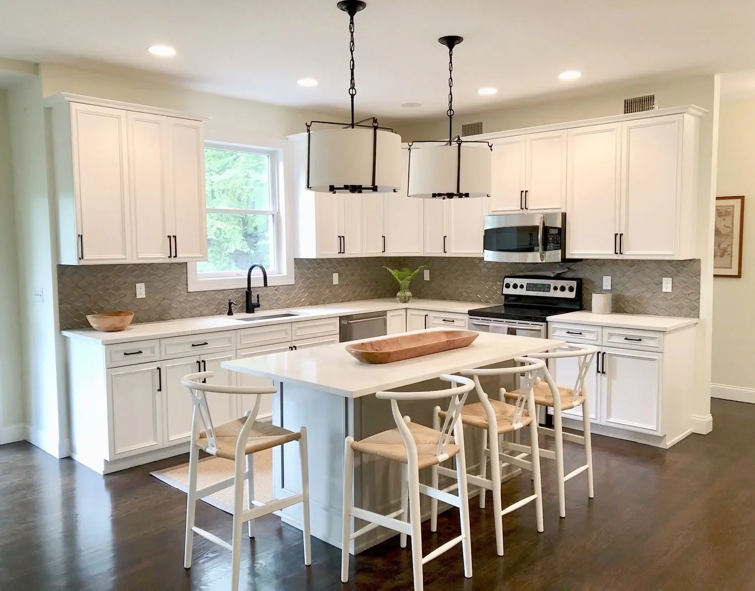Complete kitchen remodel with custom cabinetry, countertops, and backsplash installation.