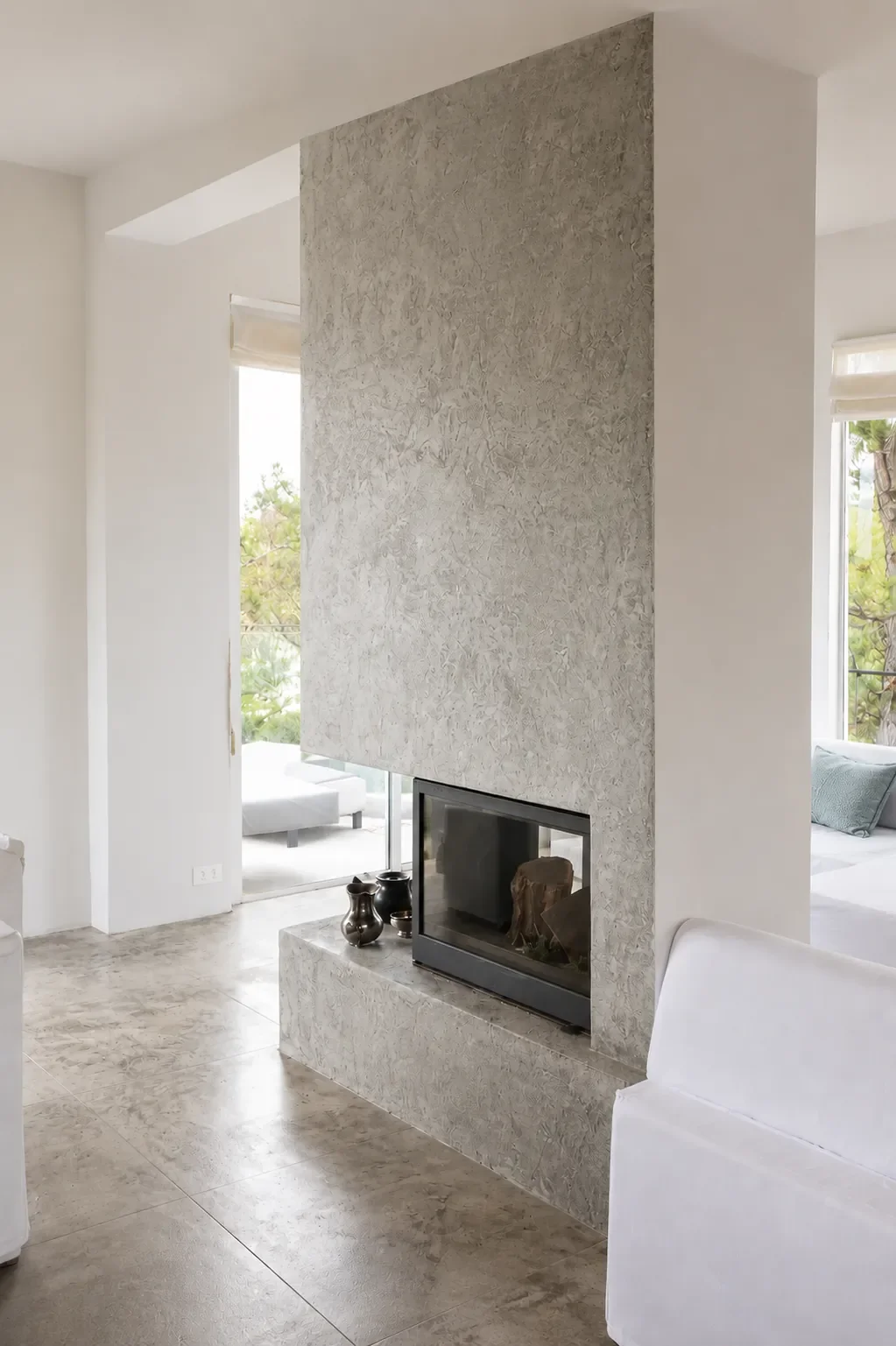 Decorative wall finish surrounding a modern fireplace.