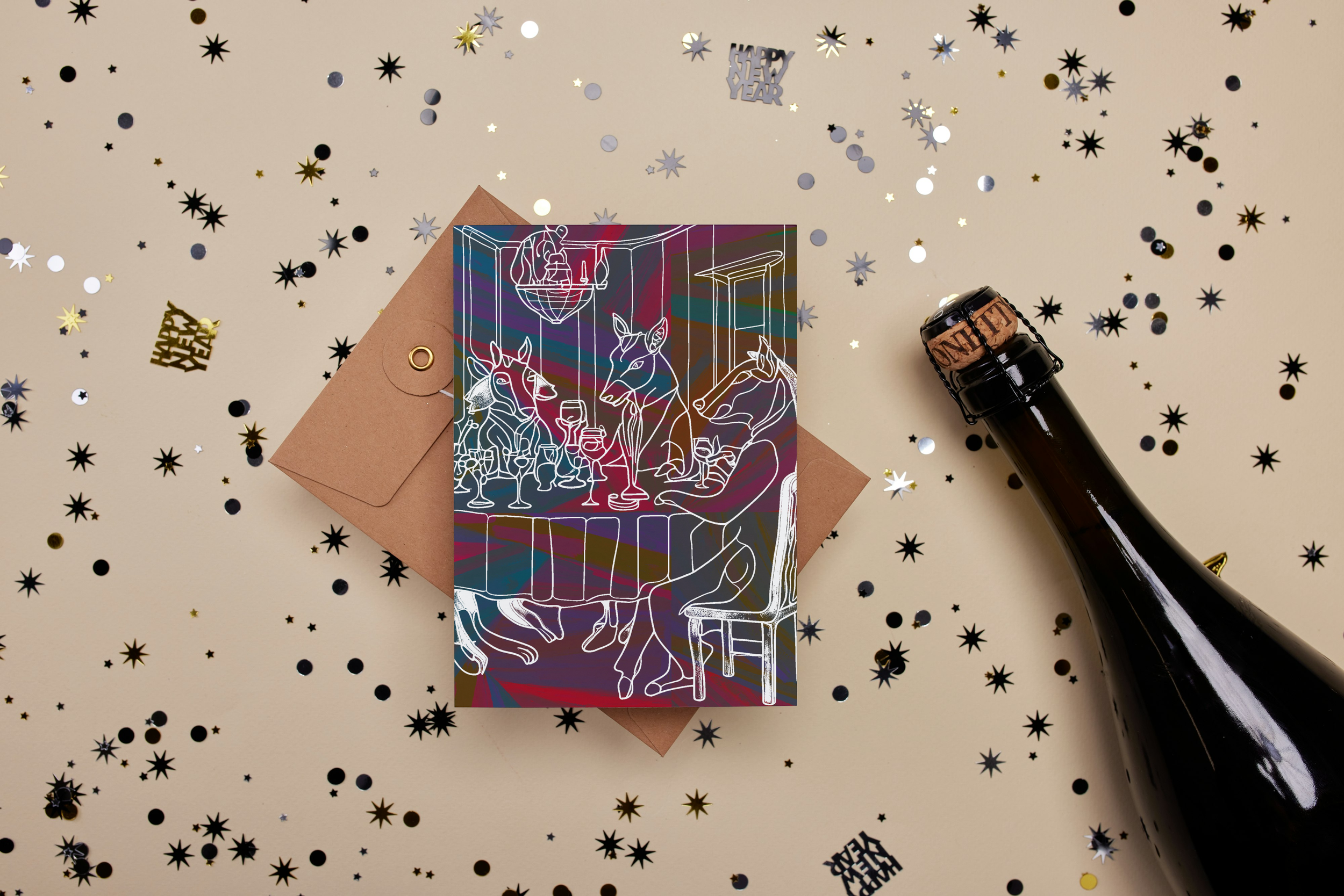 A New Year's greeting card with line art of people toasting with drinks, placed on a brown envelope. The background is scattered with shiny black, white, silver, and gold star and circle confetti, and there are "Happy New Year" and "Happy Year" cutou