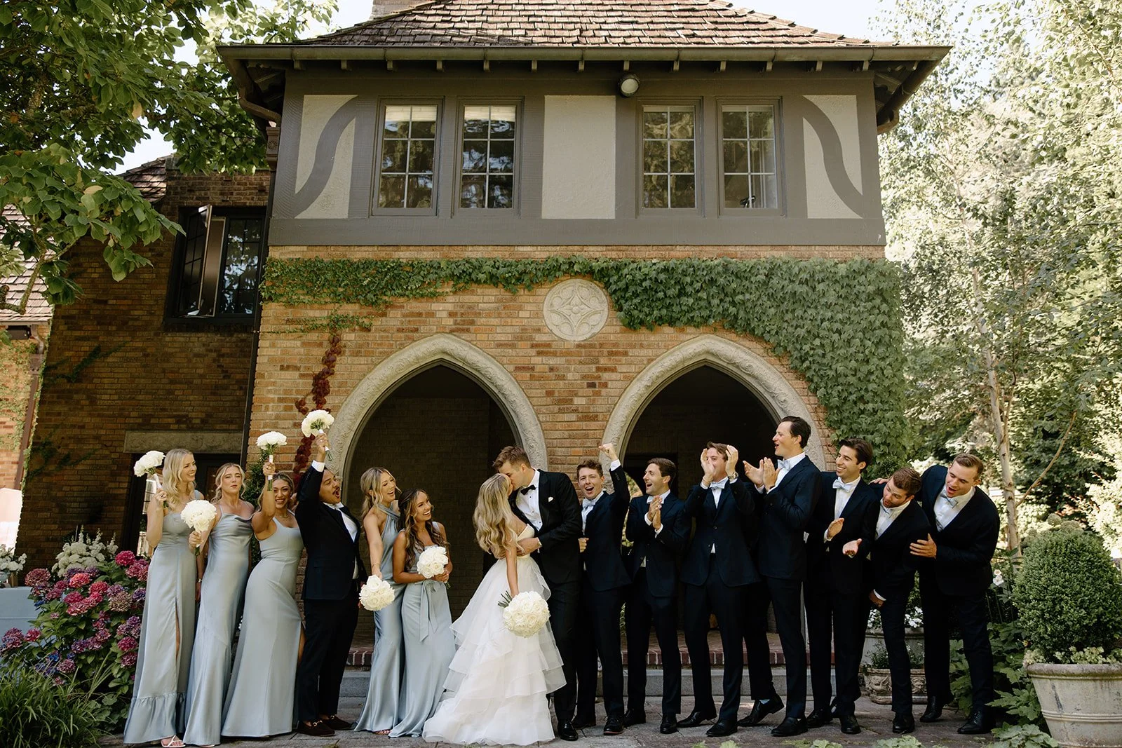 Wedding party at stone archway at The Highlands Shoreline — wedding planned by Gordon Duo Weddings