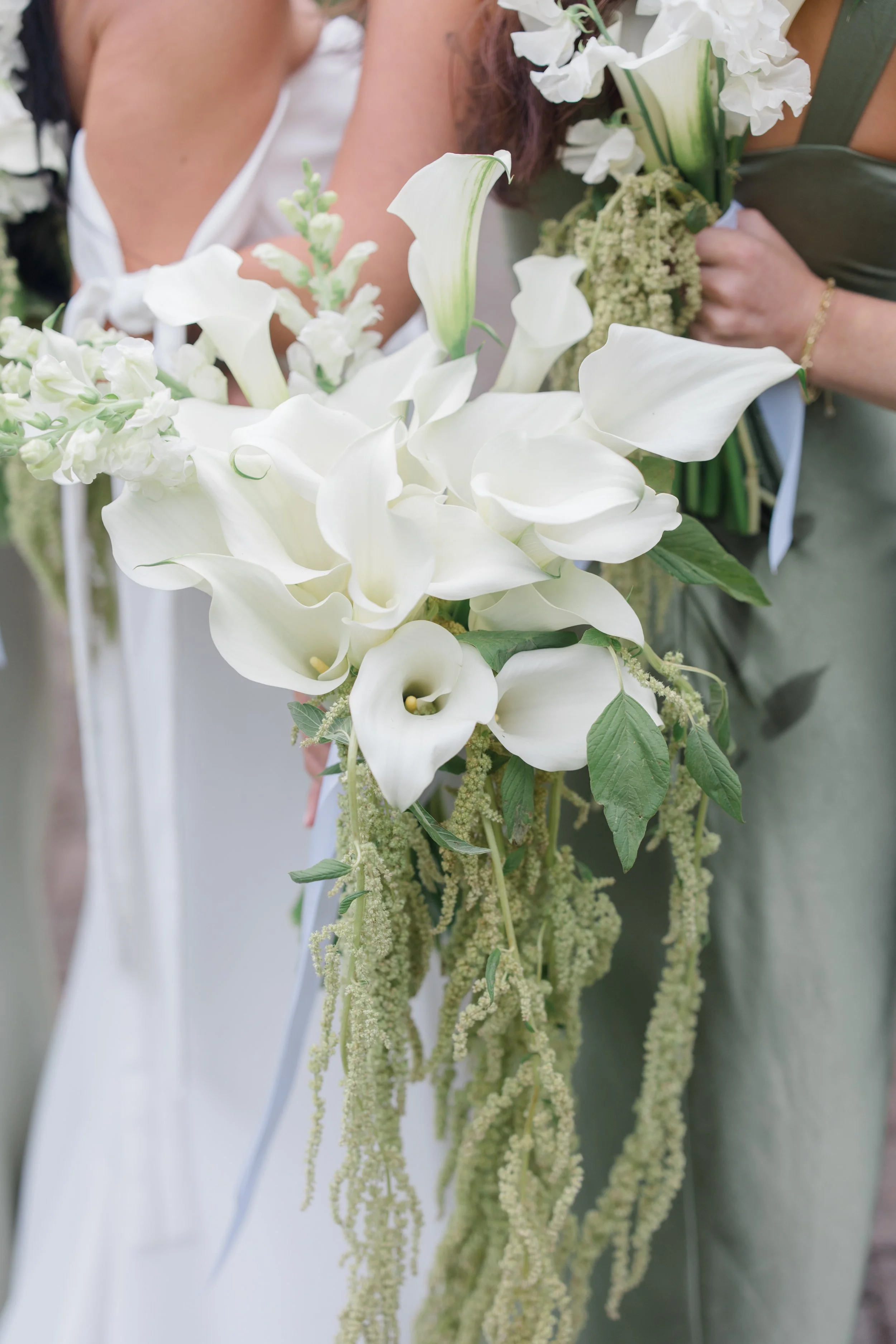 Bridal bouquet with white calla lilies and cascading greenery — wedding design by Gordon Duo Weddings at Kiana Lodge