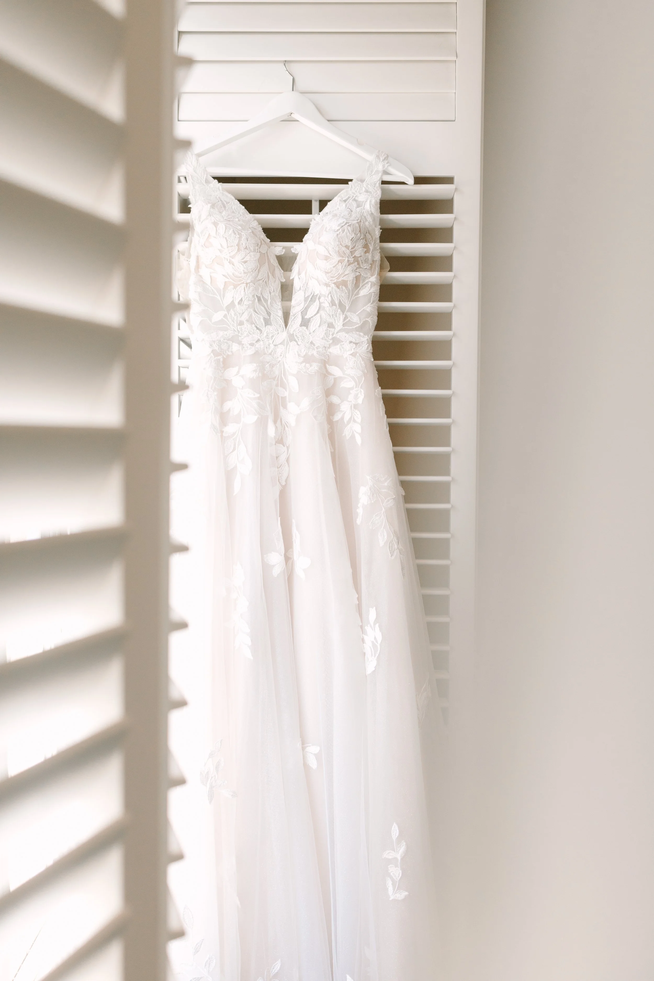 Wedding dress hanging in bridal suite at The Golf Club at Newcastle — wedding planned by Gordon Duo Weddings