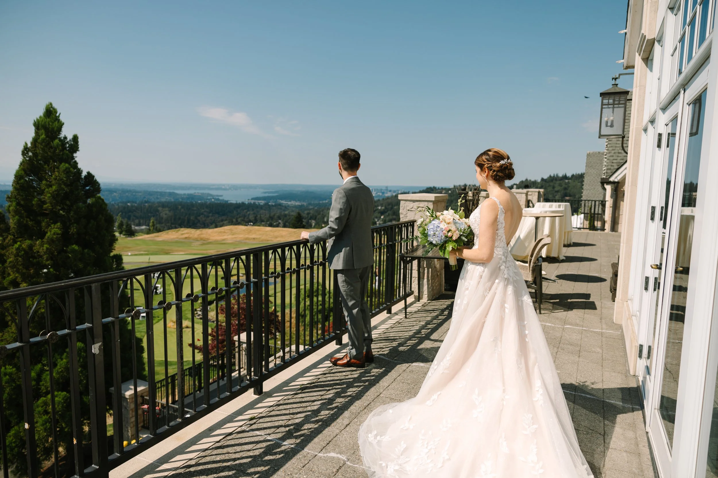 Bride and groom on terrace overlooking the Cascades and Puget Sound at The Golf Club at Newcastle — Gordon Duo Weddings