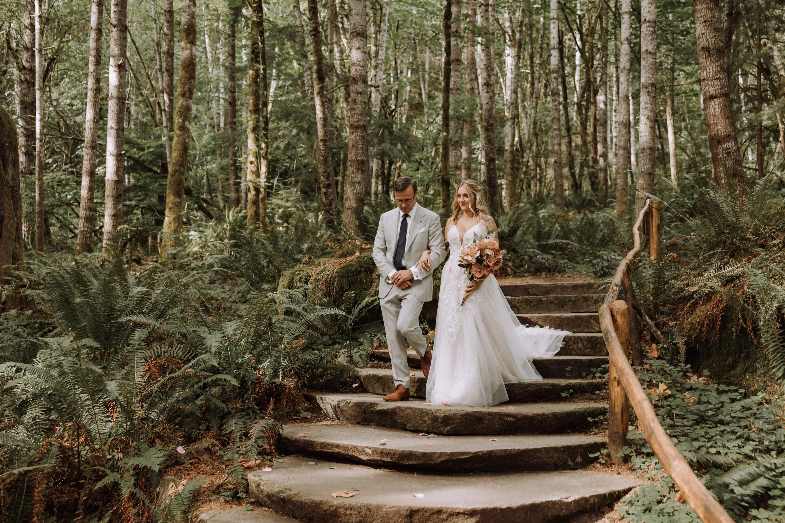 Bride walking with her father at Well Spring Spa in Ashford, WA — photo by Klear Photography