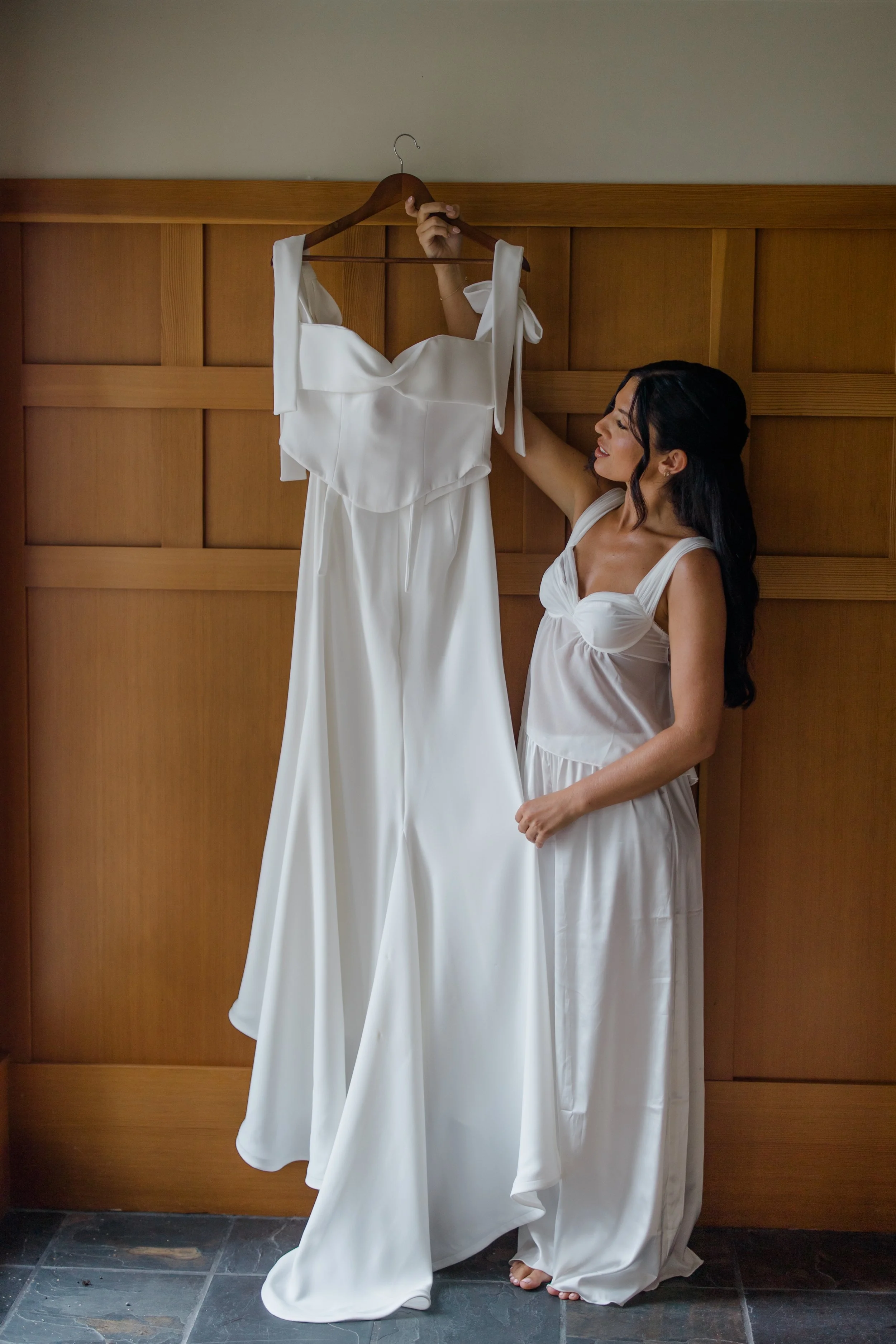 Bride getting into wedding dress at Kiana Lodge Poulsbo WA — wedding planned by Gordon Duo Weddings