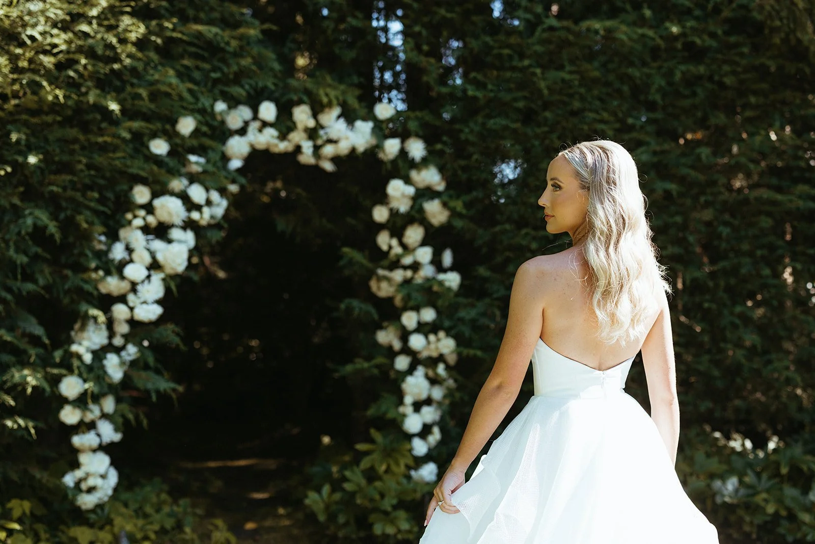 Bride standing at The Highlands Shoreline in elegant white gown — wedding planned by Gordon Duo Weddings