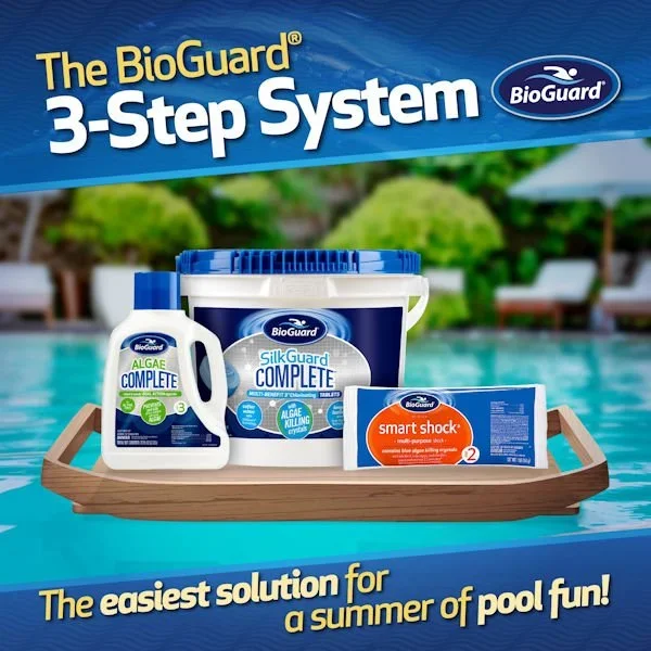 Package of BioGuard 3-step pool maintenance system with algae protect, silk guard, and smart shock, displayed on a wooden tray in front of a swimming pool with a blurred outdoor poolside background.