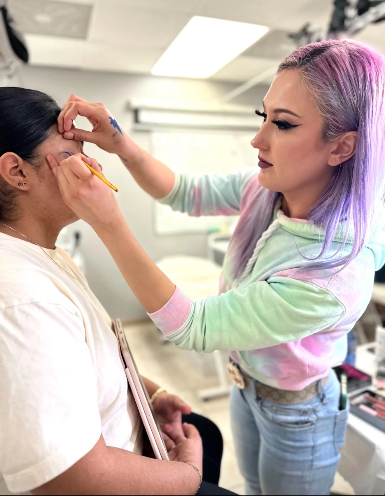 Young adult female dong eyeliner on student