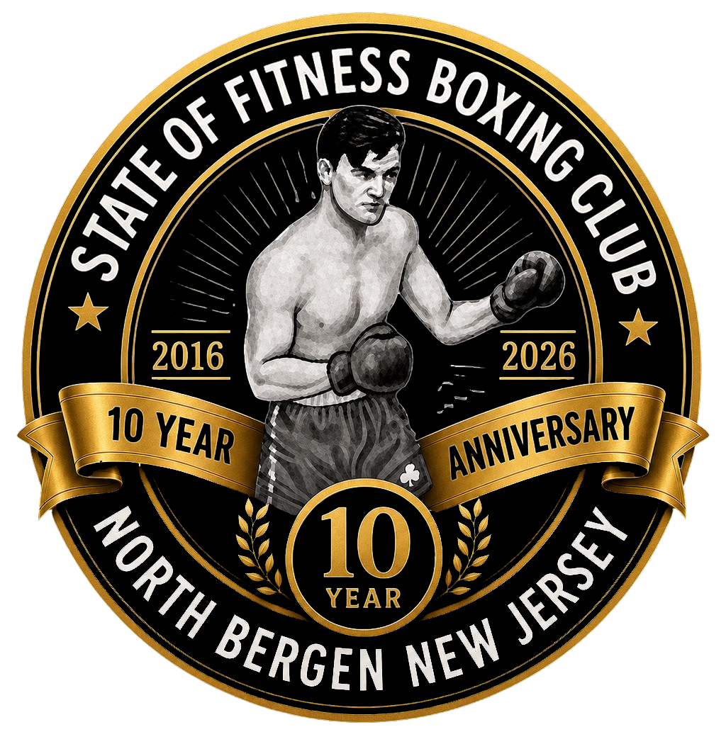 A commemorative emblem celebrating the 10-year anniversary of the North Bergen New Jersey State of Fitness Boxing Club from 2016 to 2026. The emblem features a boxer in gloves and shorts, with a gold and black design and a ribbon stating '10 Year Anniversary'.