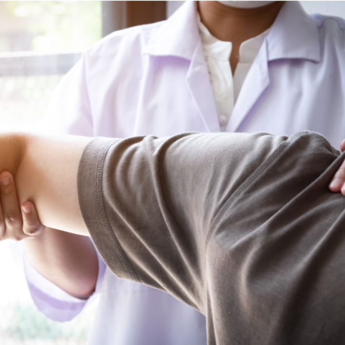 Practitioner supporting a client’s arm during a hands-on bodywork session.