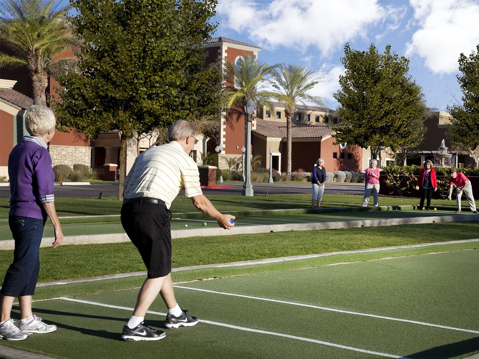 Resident playing boccee ball on the lawn near the Village Center clubhouse at Province in Maricopa, Arizona.