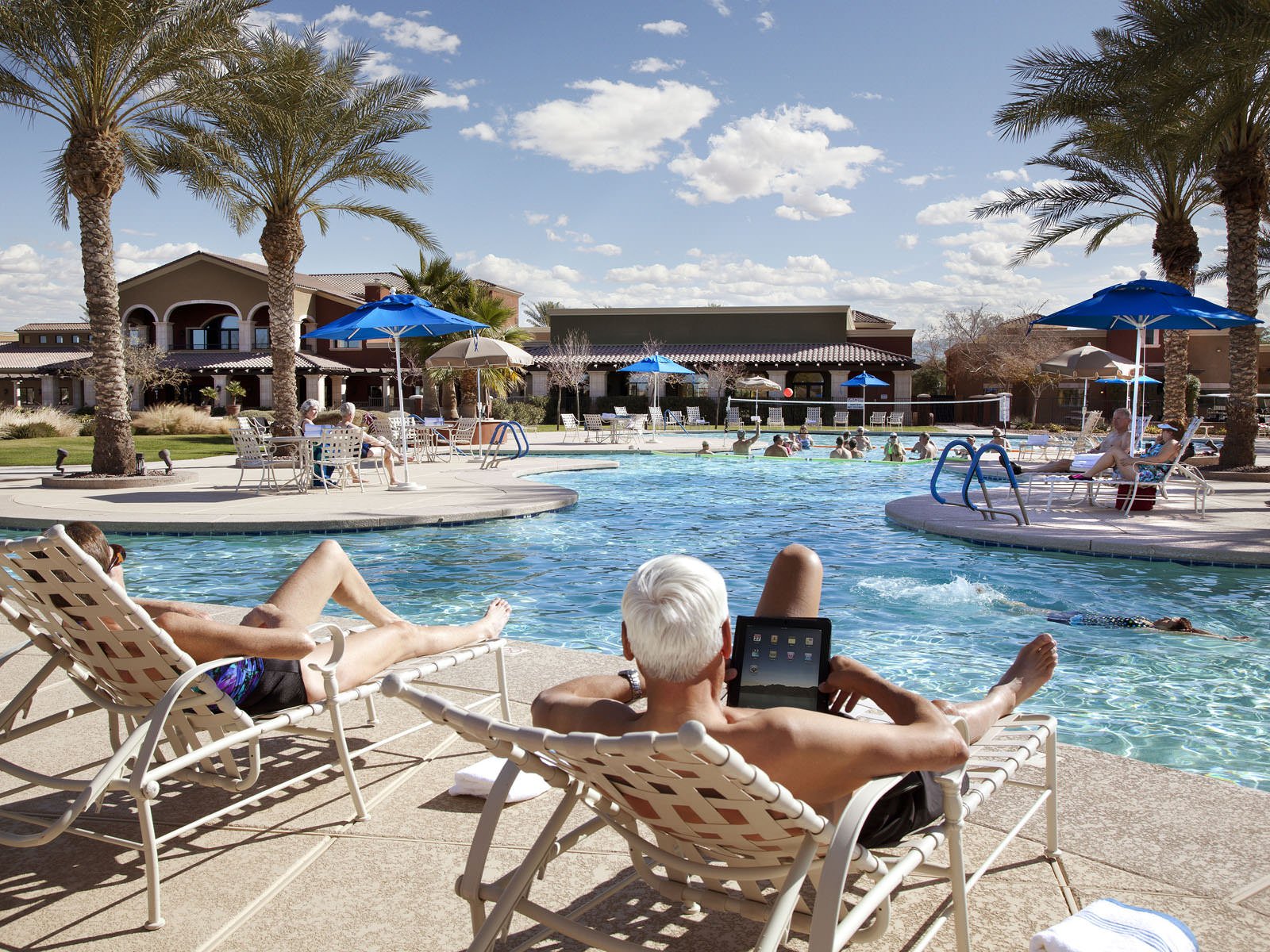Residents relaxing beside the resort-style pool at Province, a 55+ community in Maricopa, Arizona.