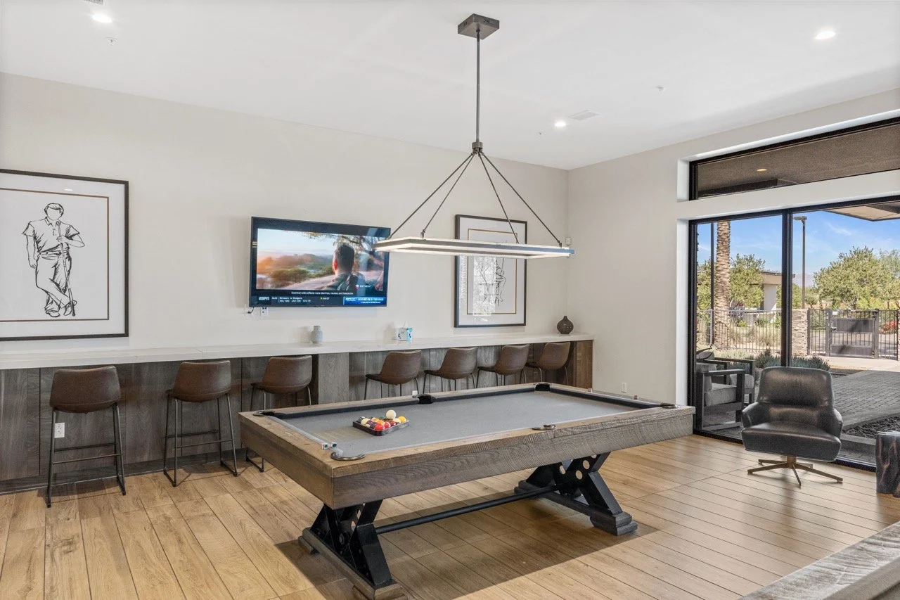 Residents enjoy the modern billiards room at Ovation at Meridian in Queen Creek, Arizona.