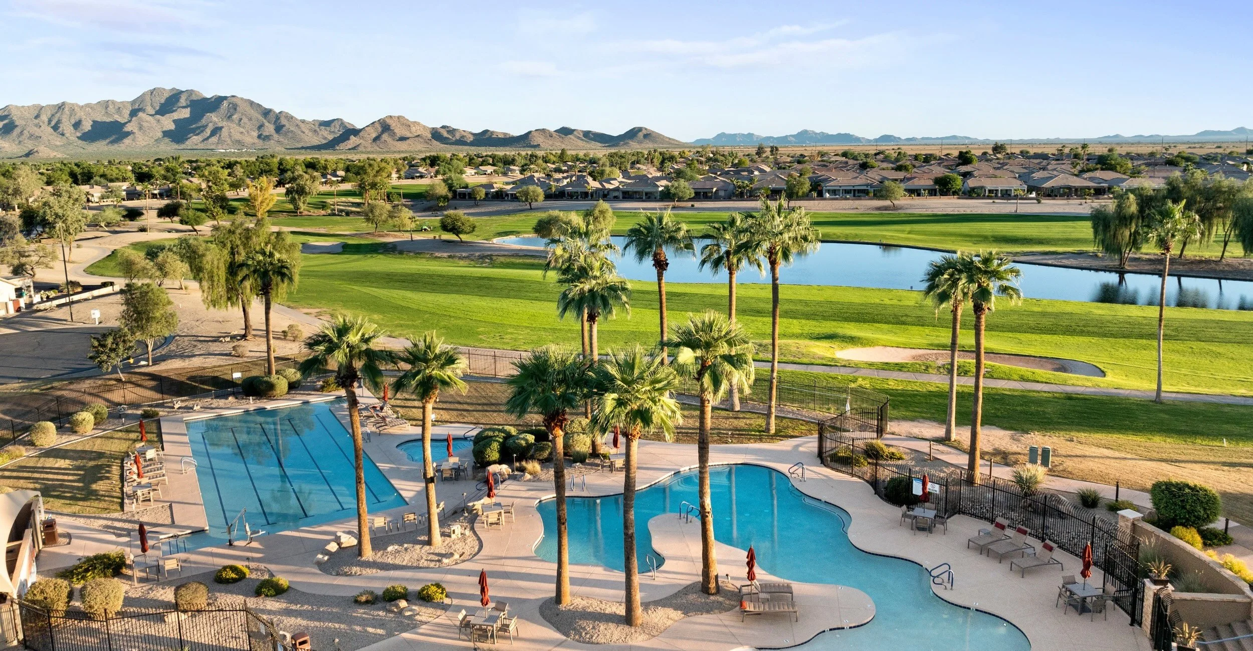 Resort-style pool overlooking Lone Tree Golf Club and lake views at Solera Chandler, a 55+ community in Chandler, Arizona.
