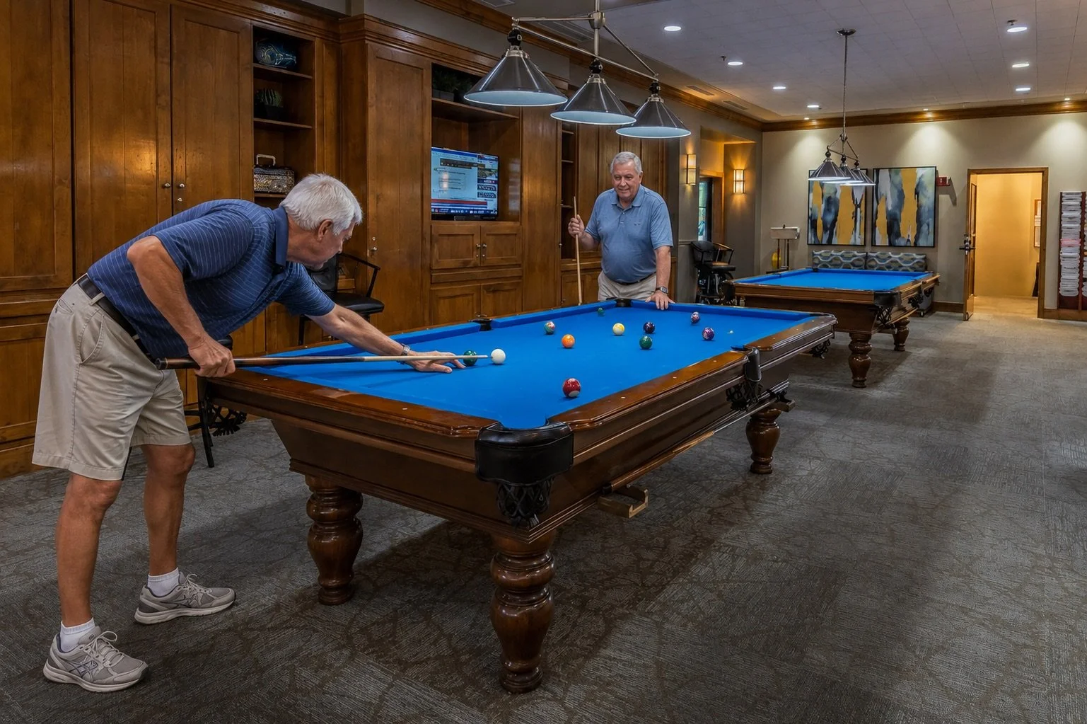 Residents enjoying the clubhouse social area and billiards table at Trilogy at Power Ranch in Gilbert, Arizona.