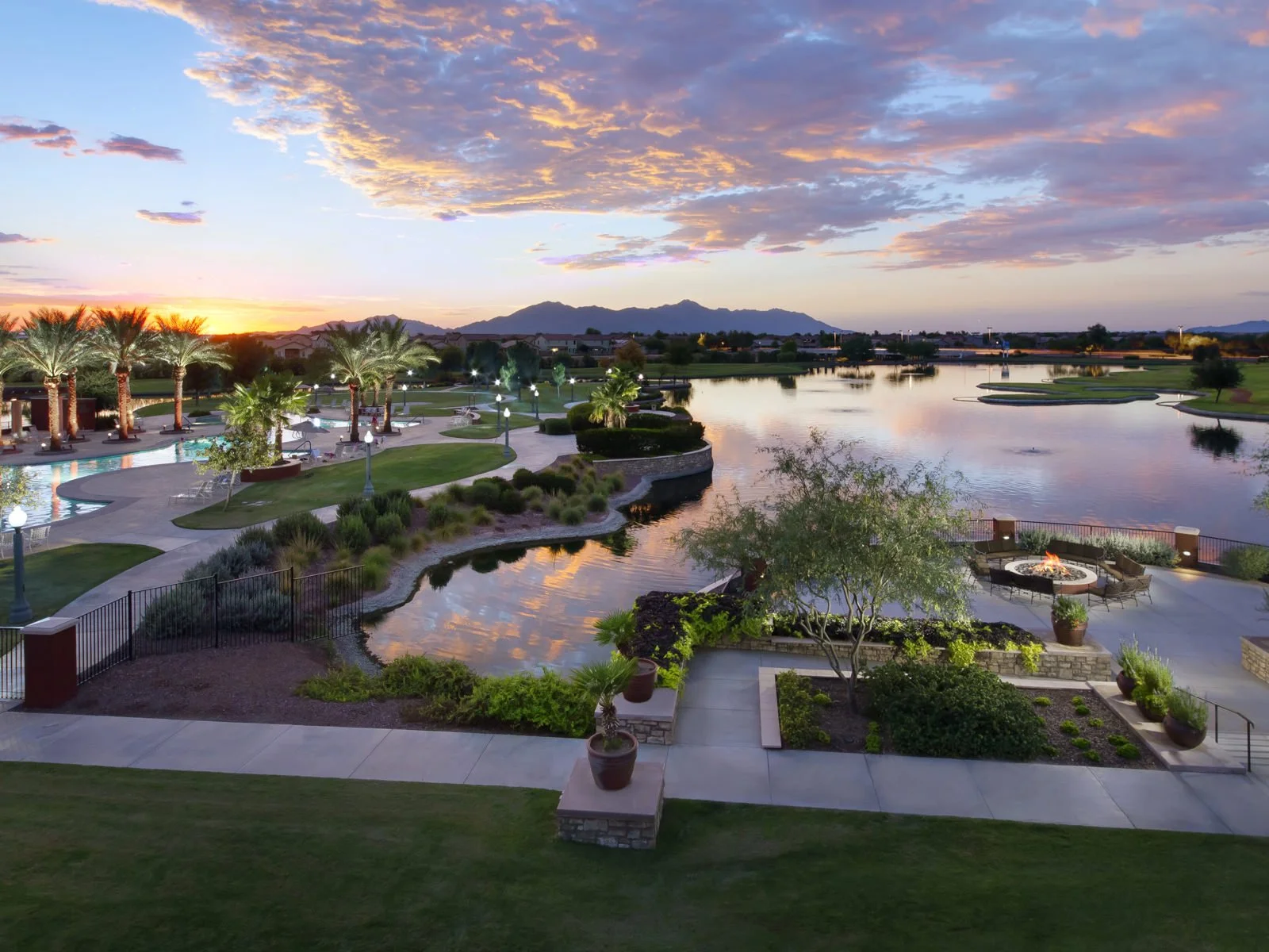 Waterfront lake views and resort-style pool within the The Village Center at Province, a 55+ community in Maricopa, Arizona.