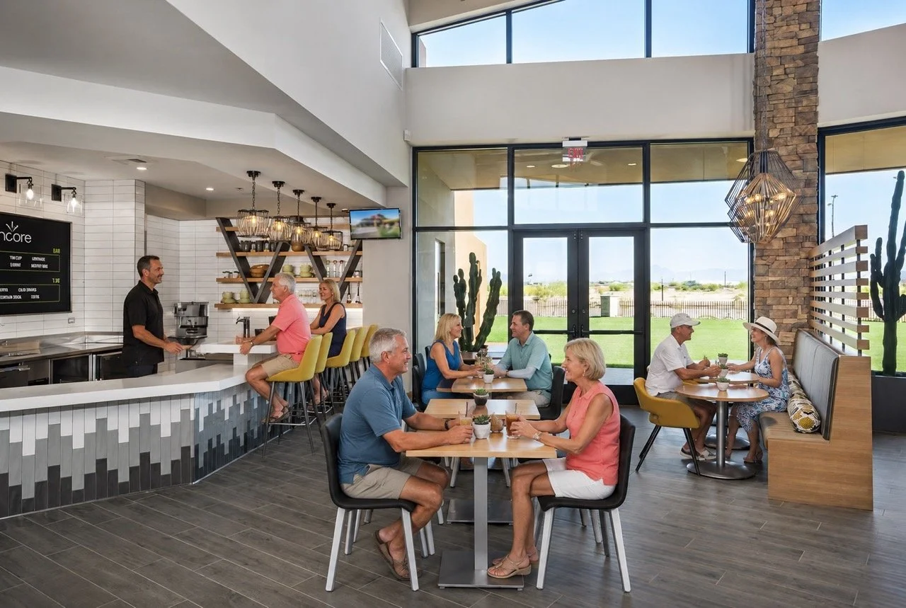 Residents enjoying coffee and conversation inside Proving Ground Cafe at Encore at Eastmark in Mesa, Arizona.