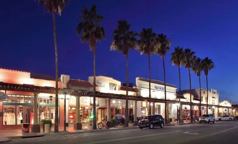 Downtown Chandler at night featuring restaurants, shopping, palm-lined streets, and a vibrant atmosphere.