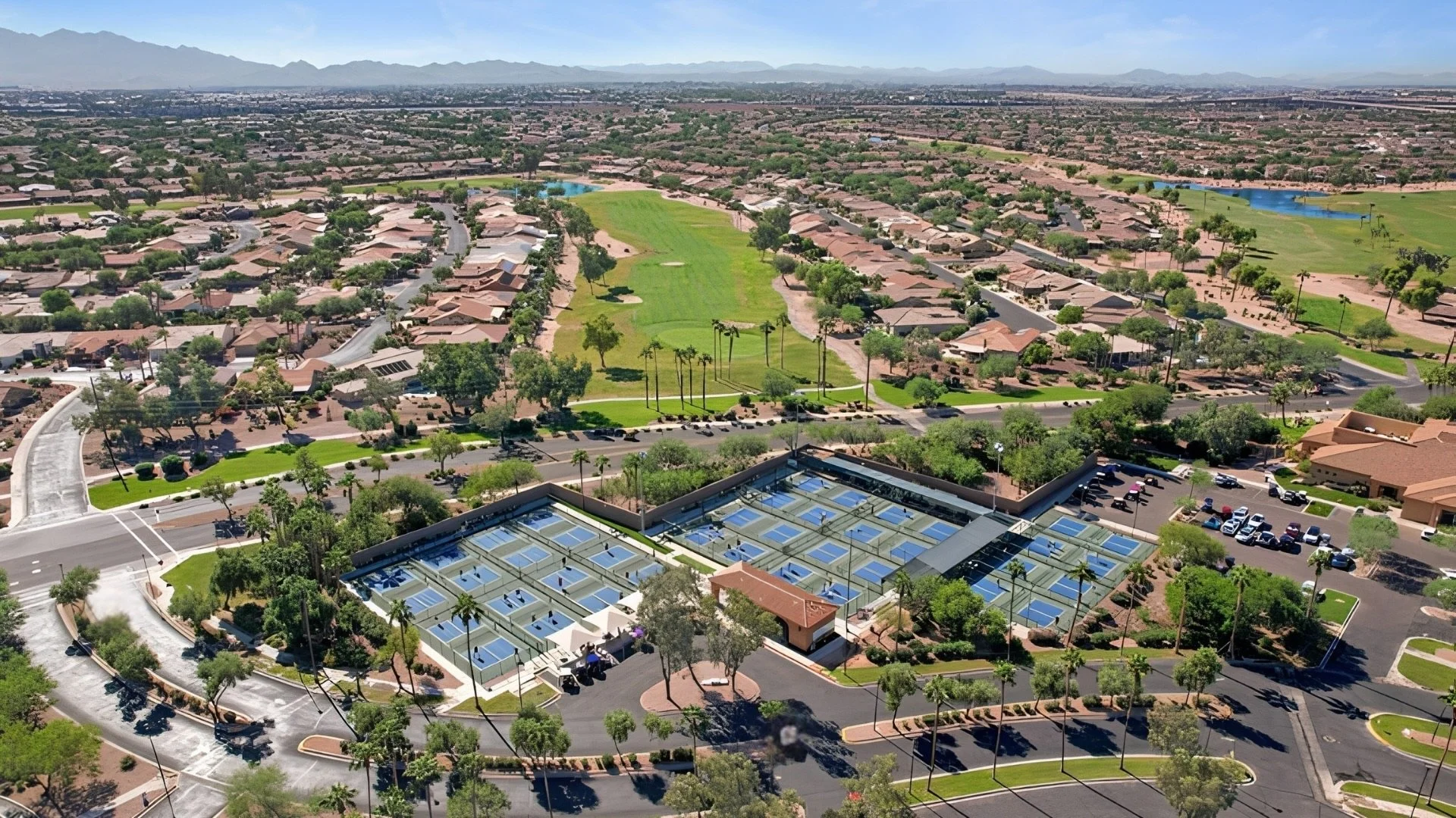 Aerial view of PebbleCreek pickleball courts with golf and mountain views