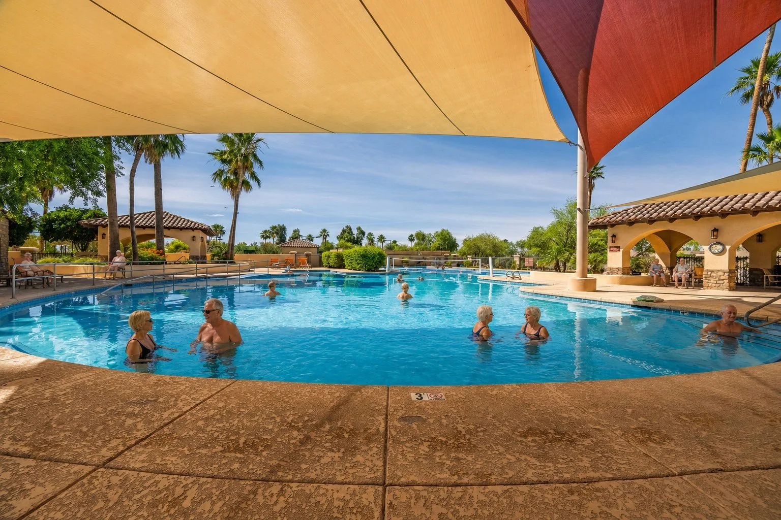 Residents enjoying the resort-style pool at Robson Ranch in Eloy, Arizona.