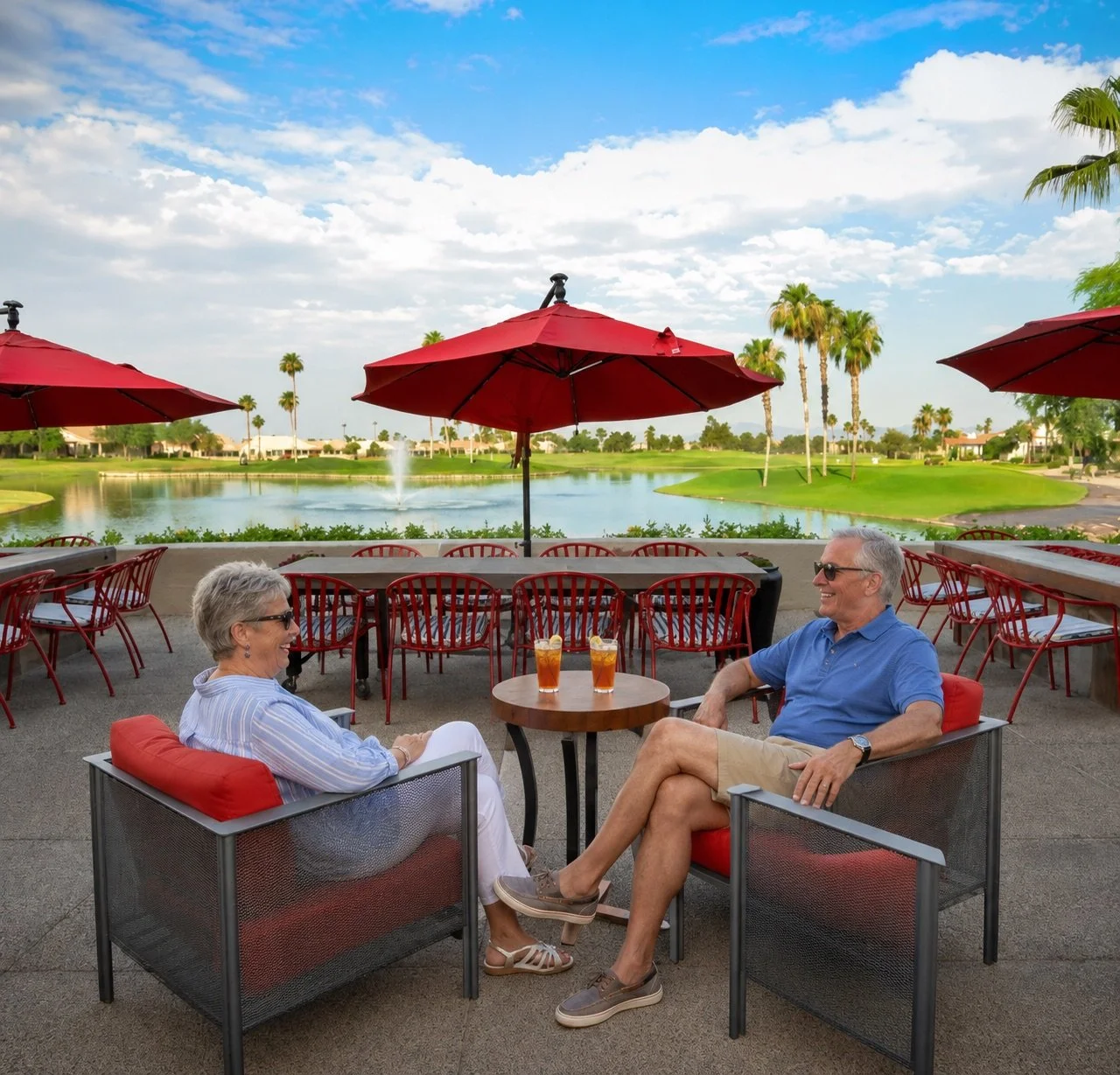 Outdoor patio seating at Stone & Barrel overlooking the pond and golf course in Sun Lakes.
