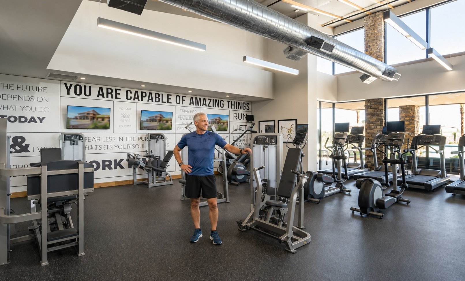 Resident using exercise equipment in the fitness center at Encore at Eastmark in Mesa, Arizona.