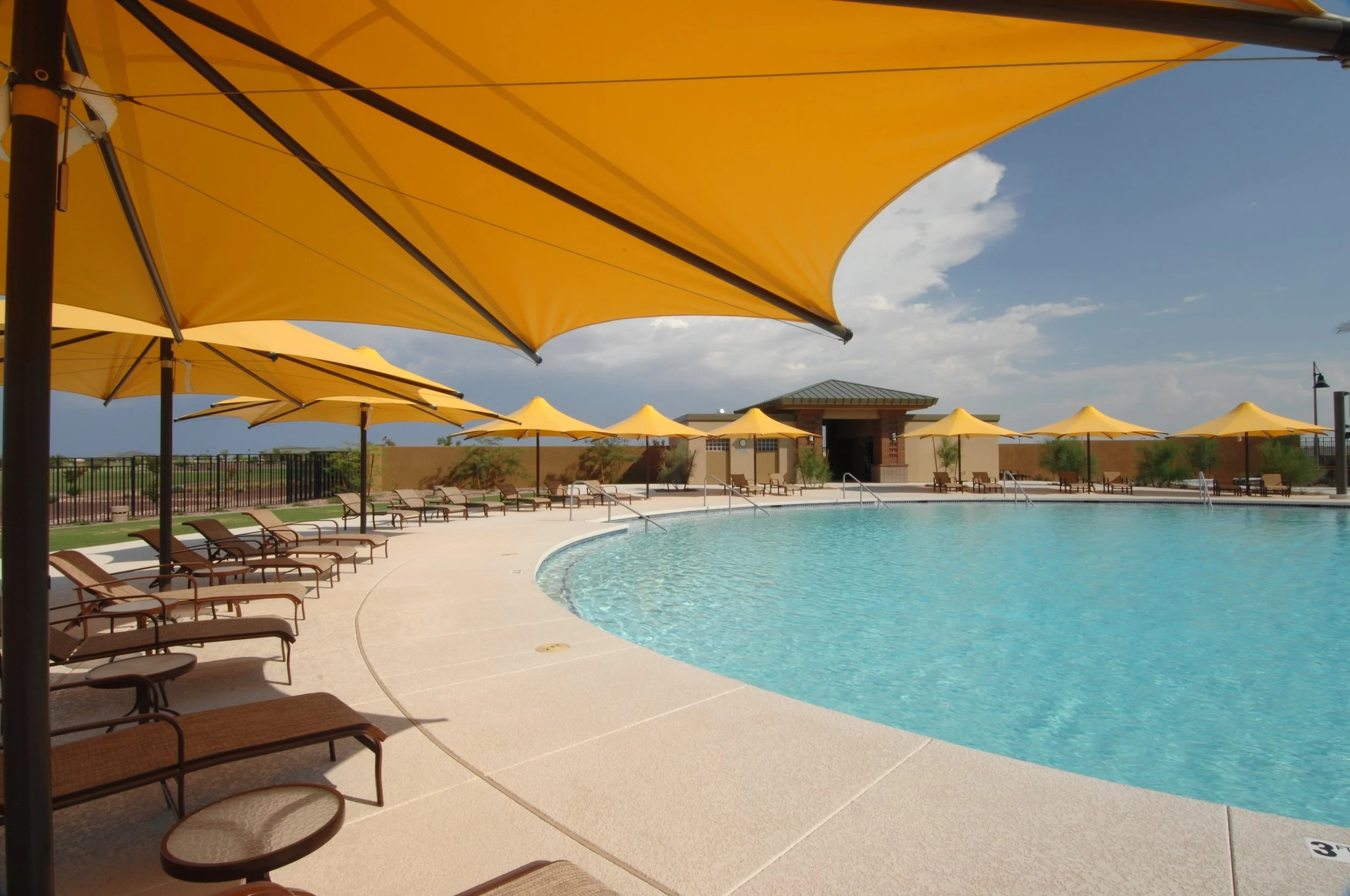 Residents enjoy the resort-style pool and shaded lounge areas at Sun City Anthem at Merrill Ranch in Florence, Arizona.