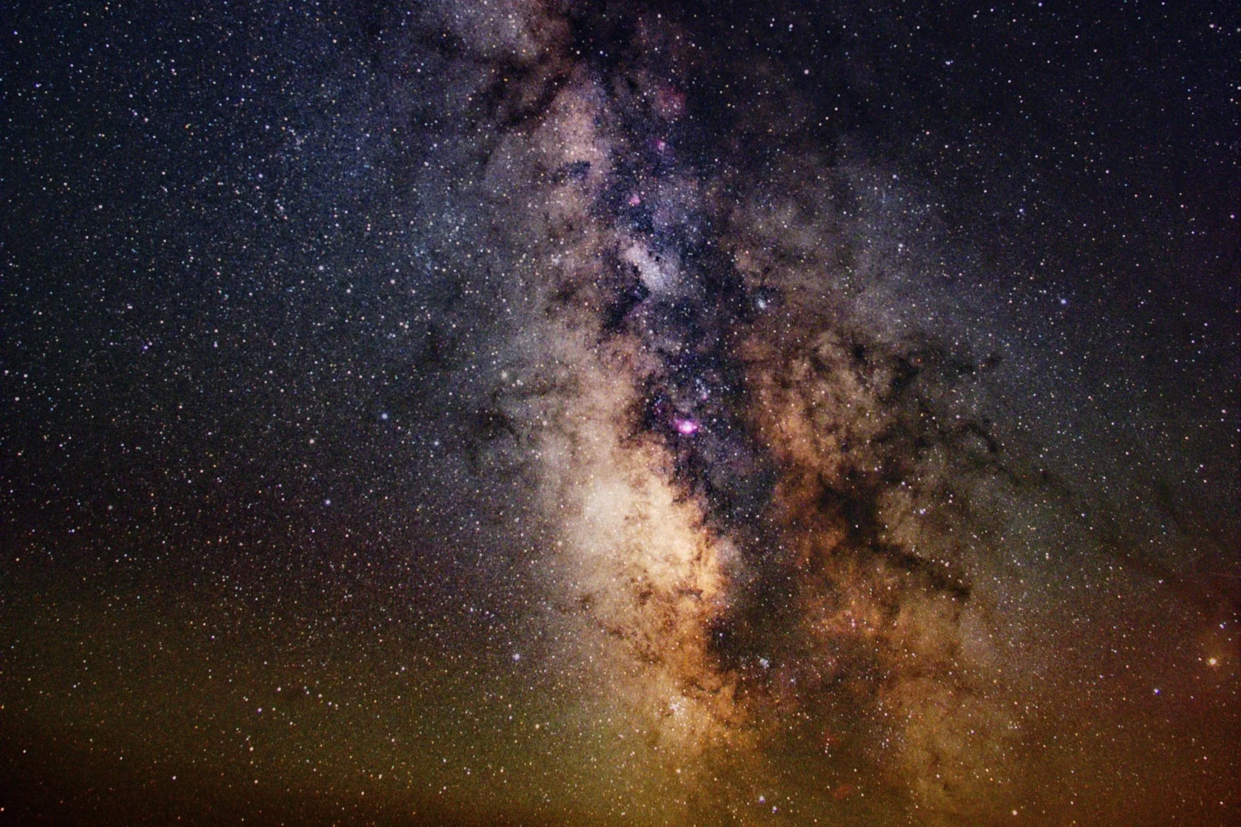 A view of the Milky Way galaxy with countless stars and cosmic dust in space.