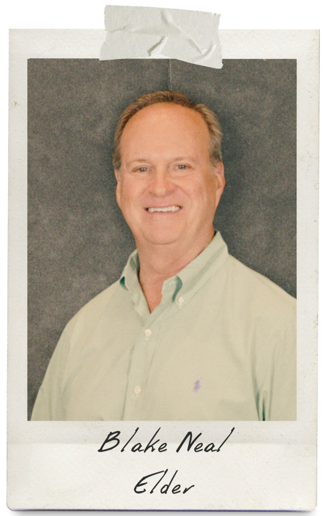 man wearing a button down shirt smiling