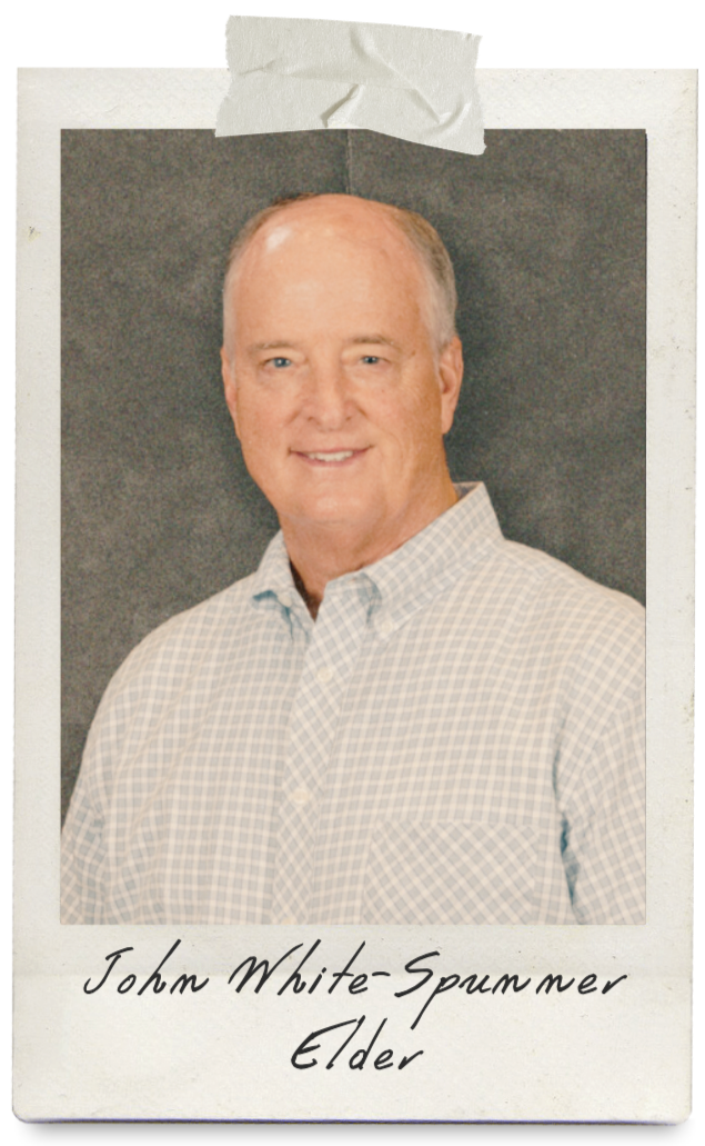 Man wearing a plaid button down shirt smiling