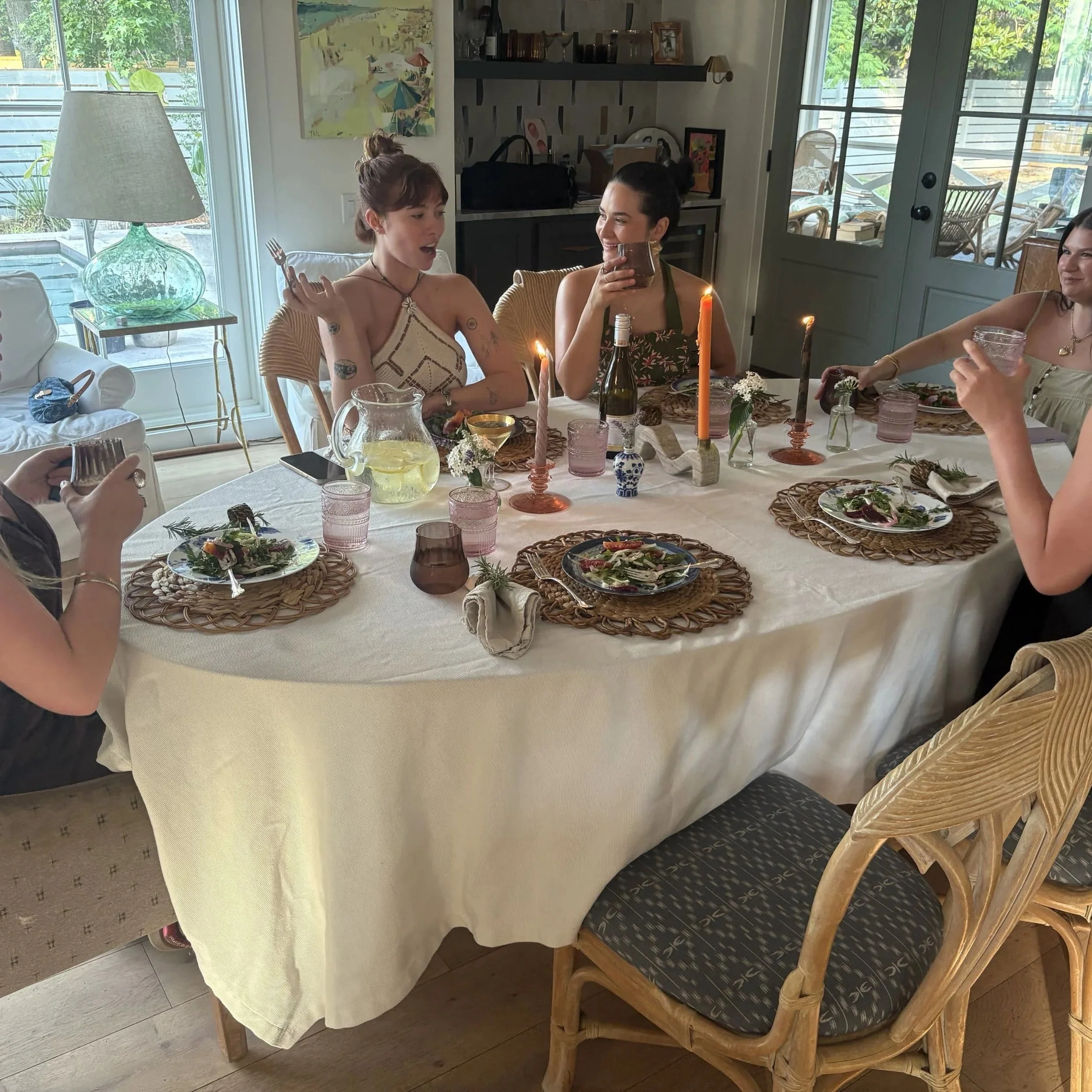 Elegant table setting with wine glasses and floral arrangements ready for an upscale in-home dinner party