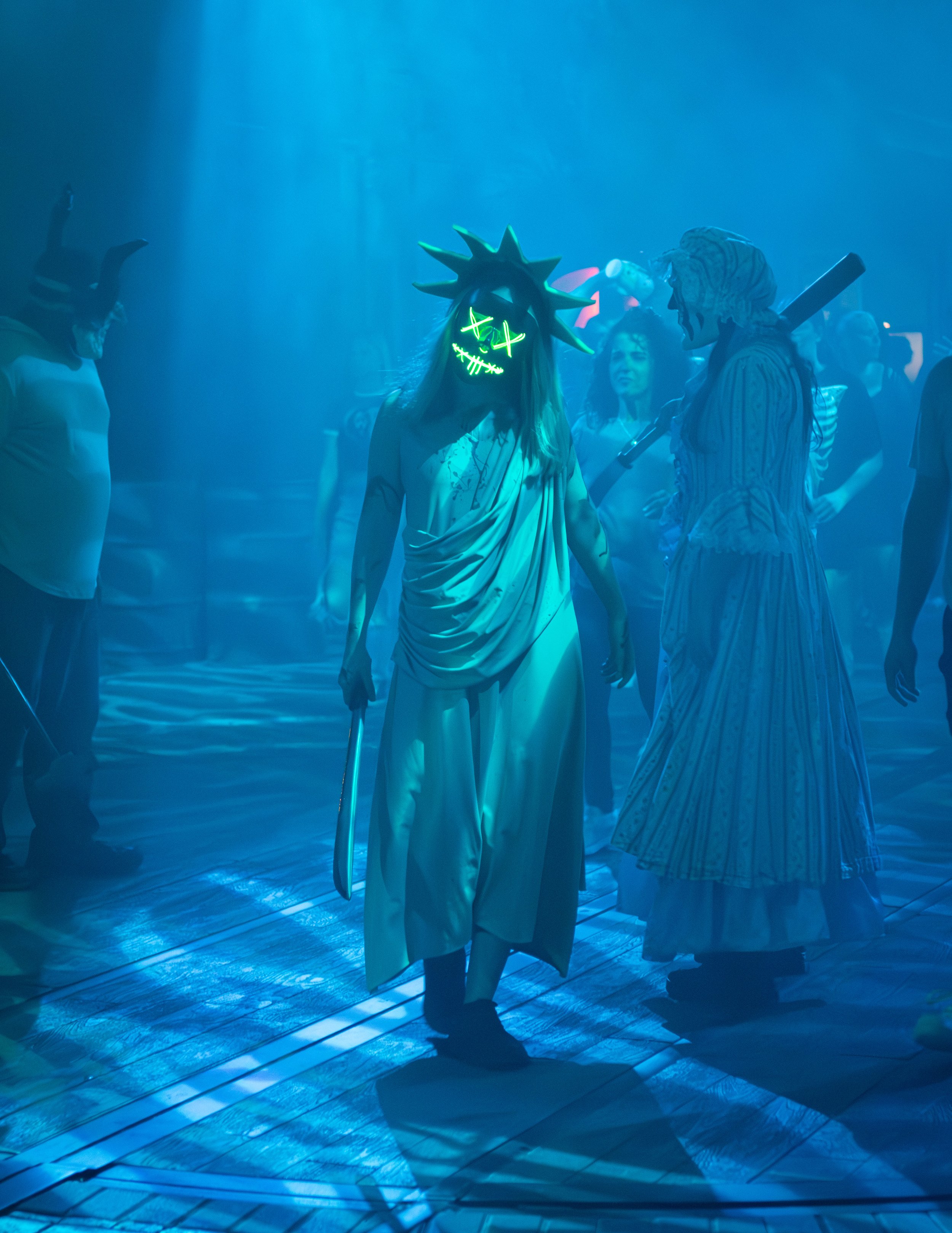 People wearing masks and costumes at a party or event with a blue lighting and wooden floor.