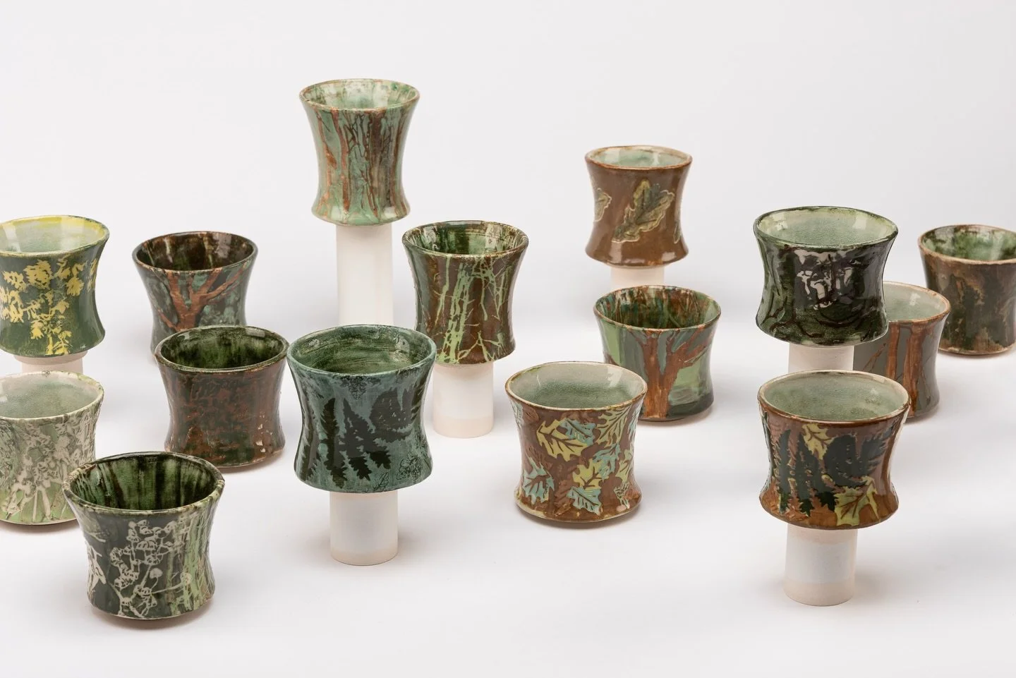 &ldquo;Community (Beginnings)&rdquo;, white stoneware, ash glazed cups, slip decorated. November 2025-January 2026
Photos by @mattdaviesimages 

This collection of cups explore the woodland as a symbiotic community, drawing parallels between ecologic