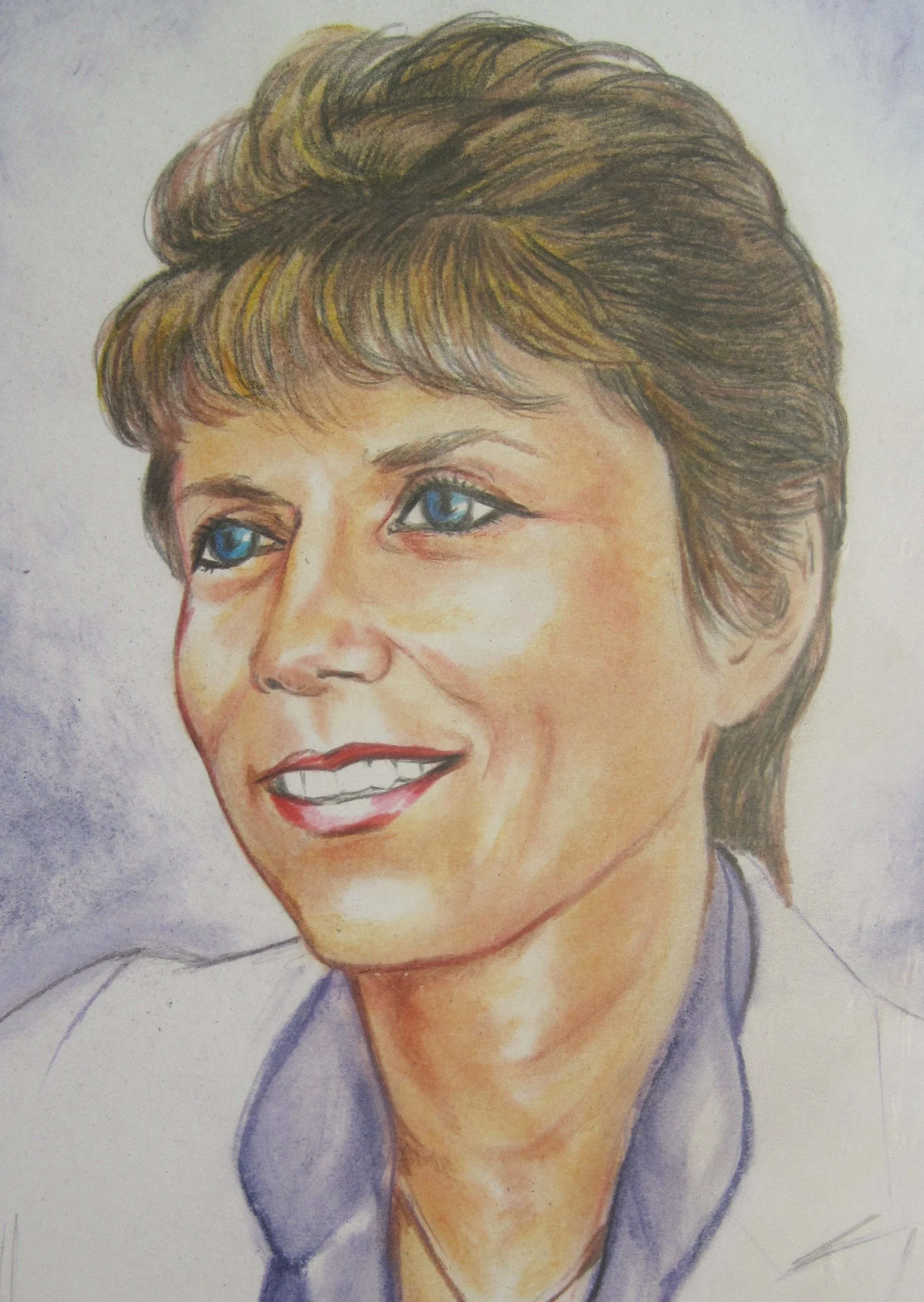Colorful portrait of a woman with short, brown hair, blue eyes, and a friendly smile, wearing a blue top.