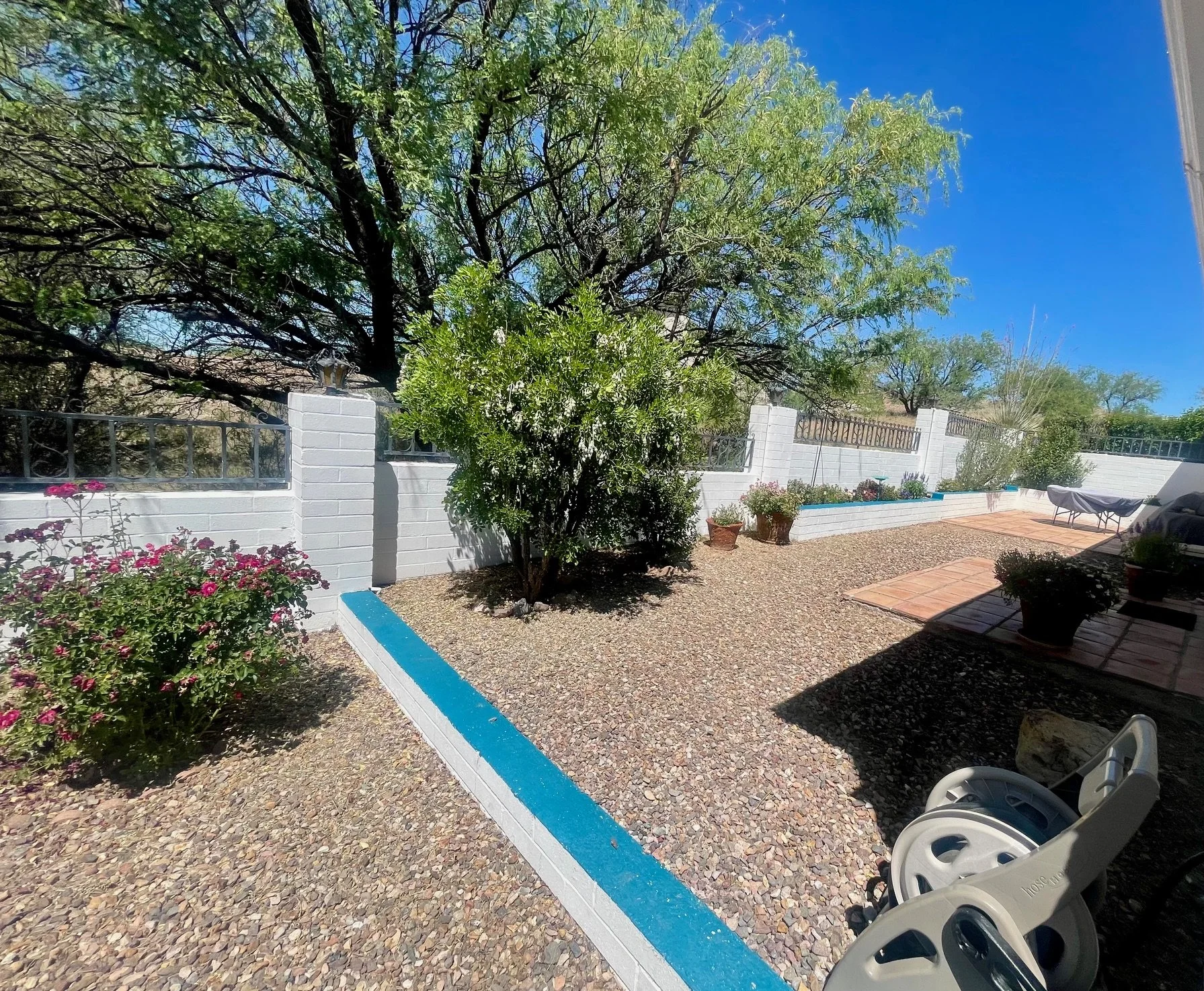Courtyard & Outdoor Living Area

Shaded Courtyard Serenity
The enclosed courtyard offers multiple spaces to gather, dine, read, or enjoy a quiet afternoon beneath the shade of mature trees. Thoughtfully landscaped with native plants and blooming flow