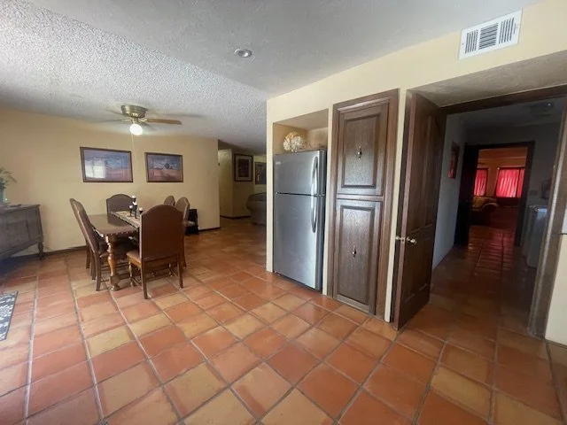 Open Dining Area

Open-Concept Living and Dining Space
This spacious dining area flows seamlessly into the kitchen and living spaces, creating an inviting atmosphere for gathering with family and friends. Warm earth tones, Saltillo tile floors, and S