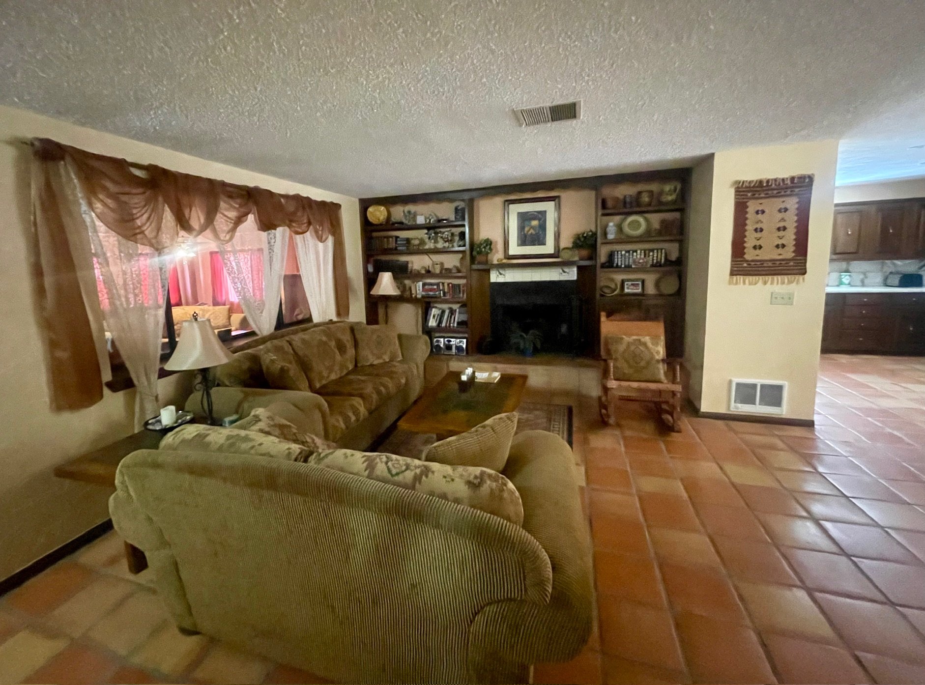 Cozy Living Room

Relax by the Fireplace
The inviting living room offers comfortable seating, built-in bookshelves, and a charming fireplace that serves as the heart of the home. Whether you're enjoying a movie night, reading a book, or gathering wit