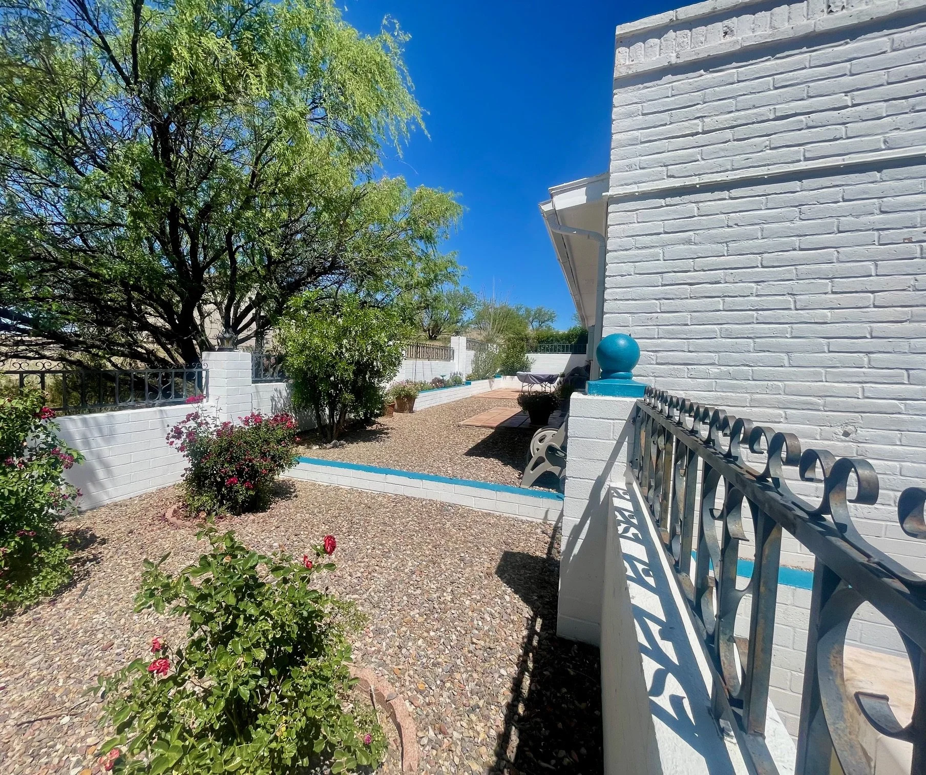 Garden Walkway & Courtyard Views

Southwestern Charm Around Every Corner
Beautiful white masonry walls, colorful accents, and flourishing desert gardens create a welcoming outdoor environment that reflects the authentic character of Patagonia and the