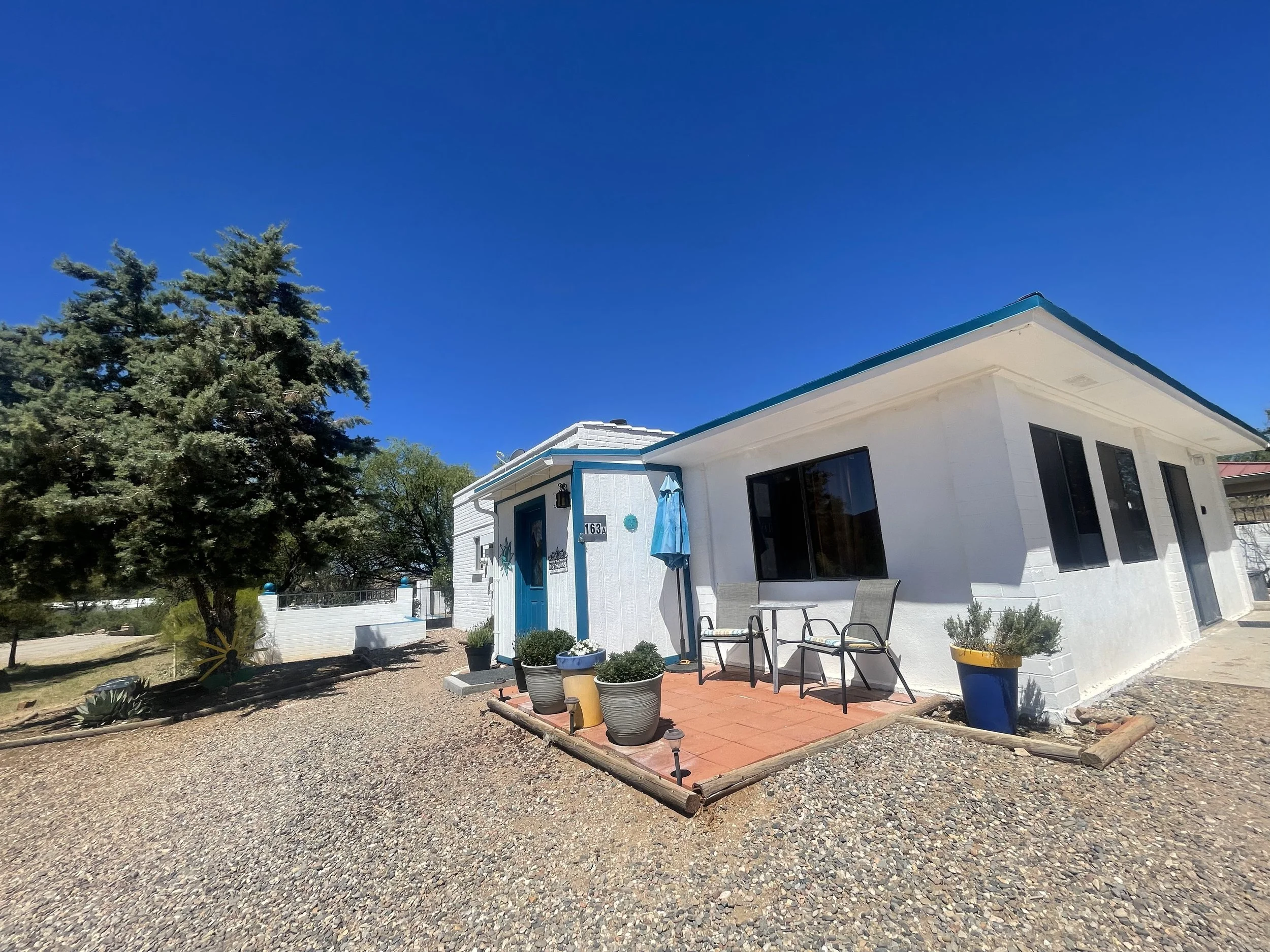 Front Patio & Gathering Space

Quiet Moments in the High Desert
Relax in the comfortable front seating area while taking in the property's tranquil desert setting. This sunny patio is perfect for reading, sipping coffee, or simply enjoying the slower